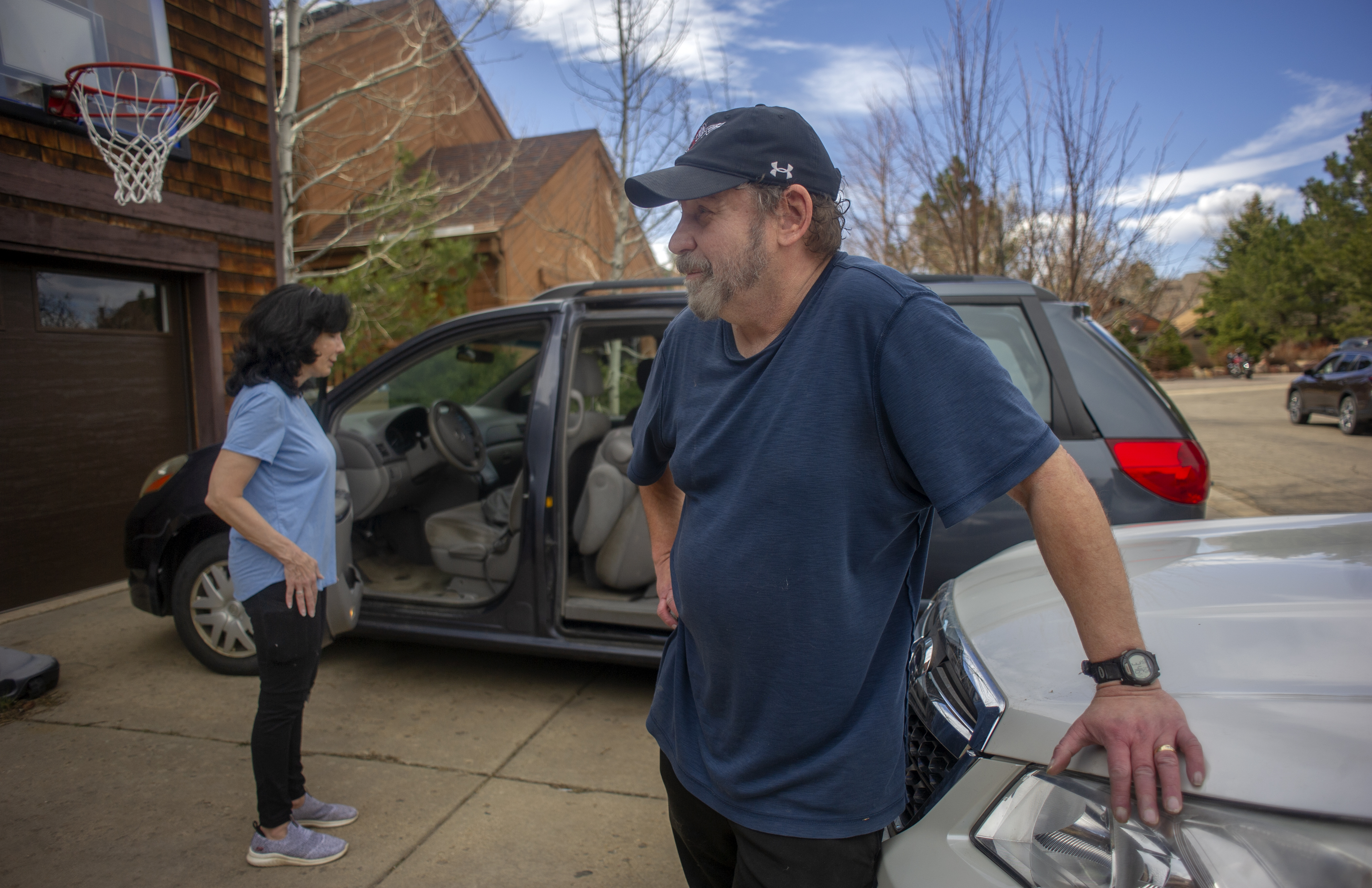 Steve Gimpel, who has been a resident of south Boulder since 1999, pauses, while he and his wife Bernadette (back) contemplate any other items they wish to evacuate, while fleeing the NCAR Fire on March 26, 2022, in Boulder, Colo. (Jacob Byk/ For The Denver Gazette)