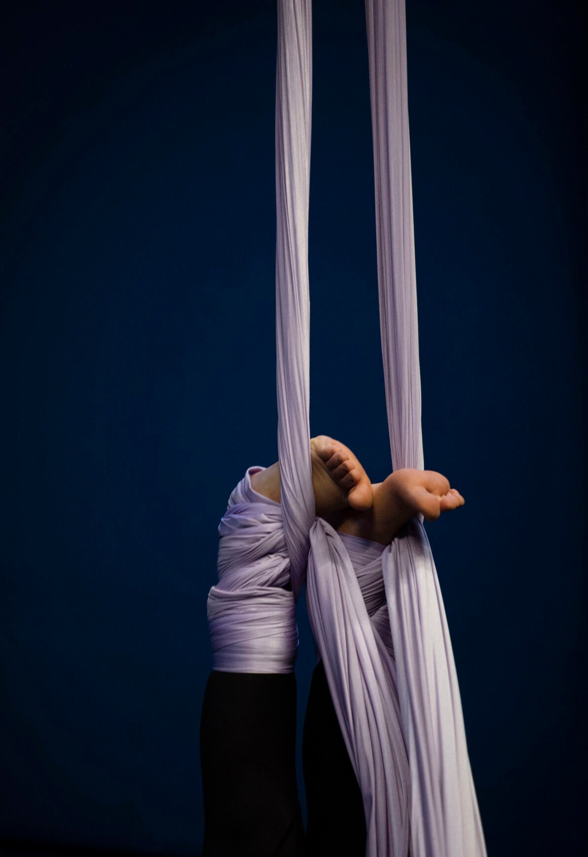 Brianna Mix, 13, is suspended upside down by an aerial silk at Urban Cirque studio in Colorado Springs on Tuesday, March 15, 2022. Owner Katrina Diaz opened her studio in January, where she shares her passion of circus-style fitness with teens and adults, teaching the art of silks, hoops and aerial fitness ranging from beginner to intermediate classes. (Chancey Bush /The Gazette) (Chancey Bush/ The Gazette)