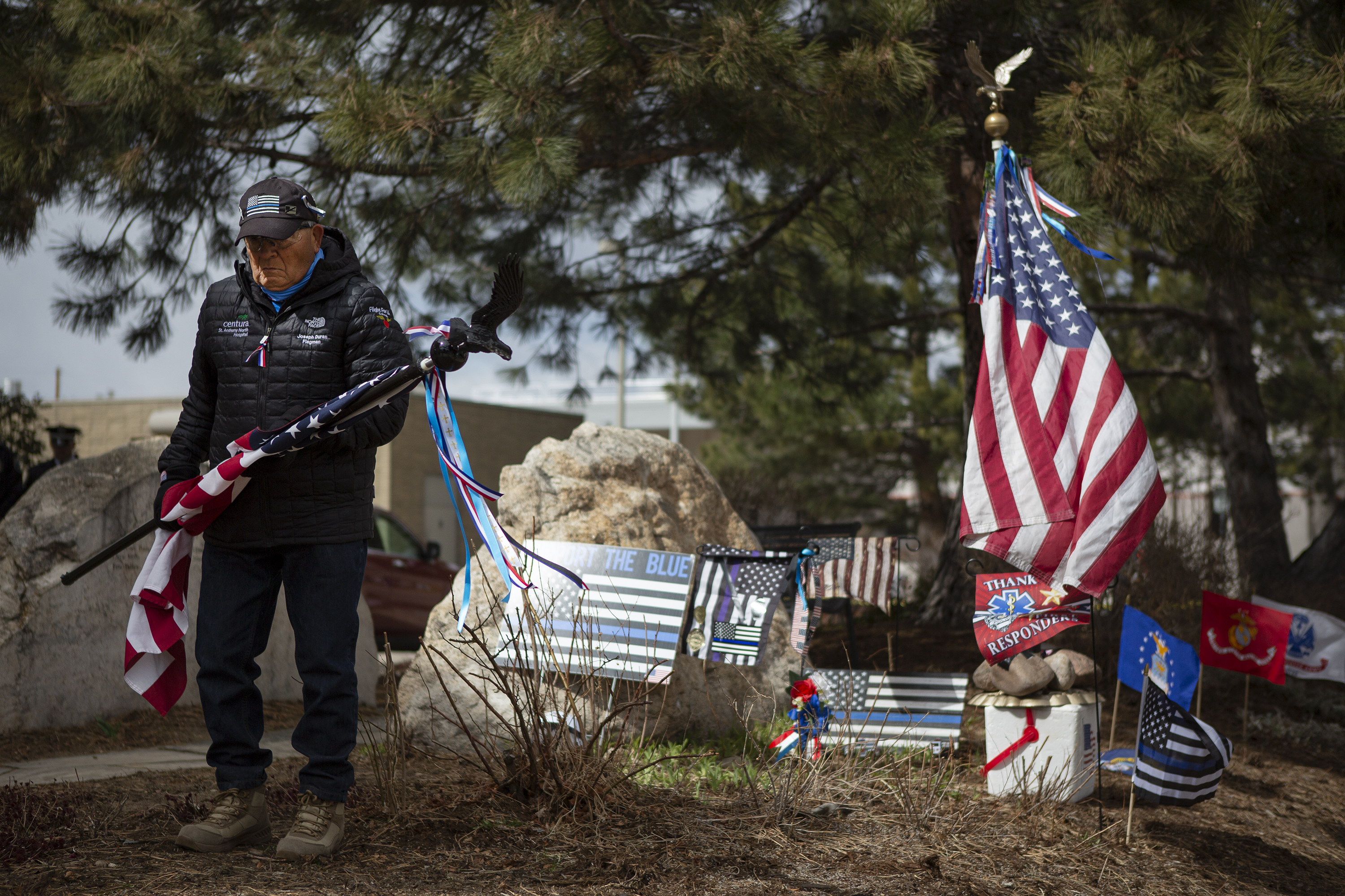 Joe Duran stand off to the side holding a flag during a Line of Duty Death commemoration for officer Eric Talley at the Boulder Police Department on Tuesday, March 22, 2022, in Boulder, Colo. (Timothy Hurst/The Denver Gazette) (Timothy Hurst)