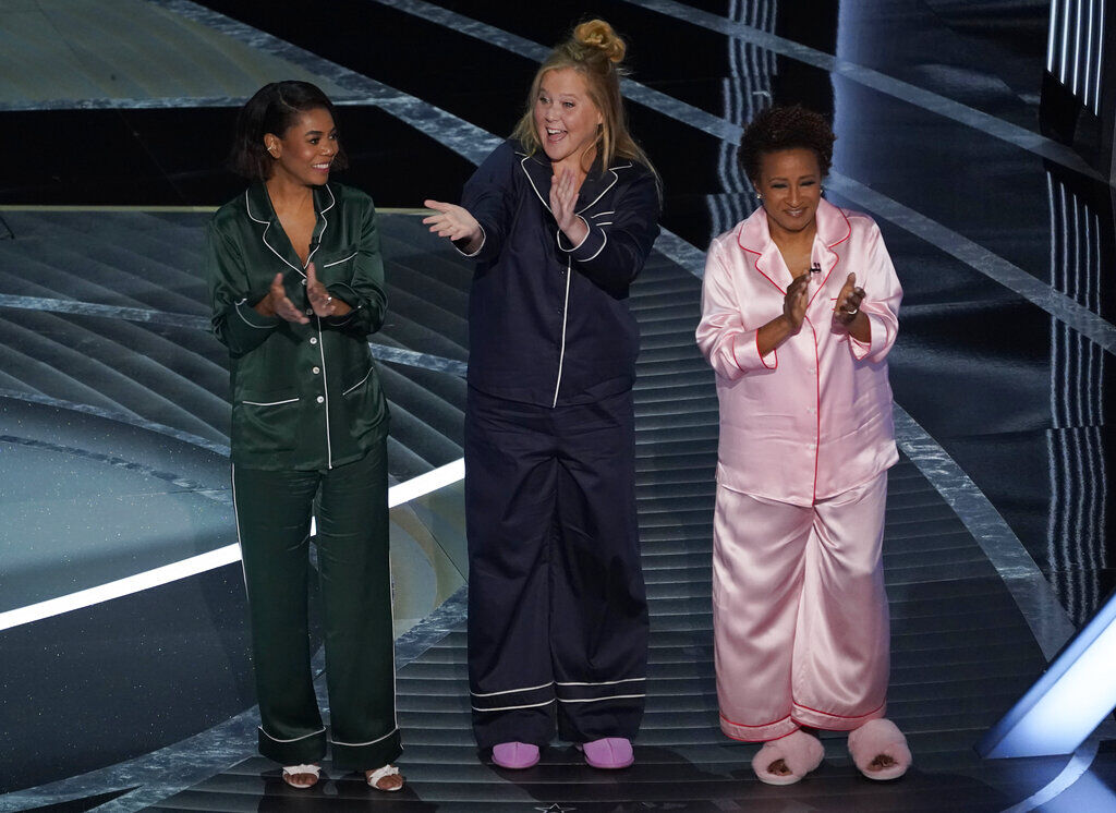 Hosts Regina Hall, from left, Amy Schumer and Wanda Sykes appear on stage in pajamas at the end of the Oscars on Sunday, March 27, 2022, at the Dolby Theatre in Los Angeles. (AP Photo/Chris Pizzello) (Chris Pizzello)