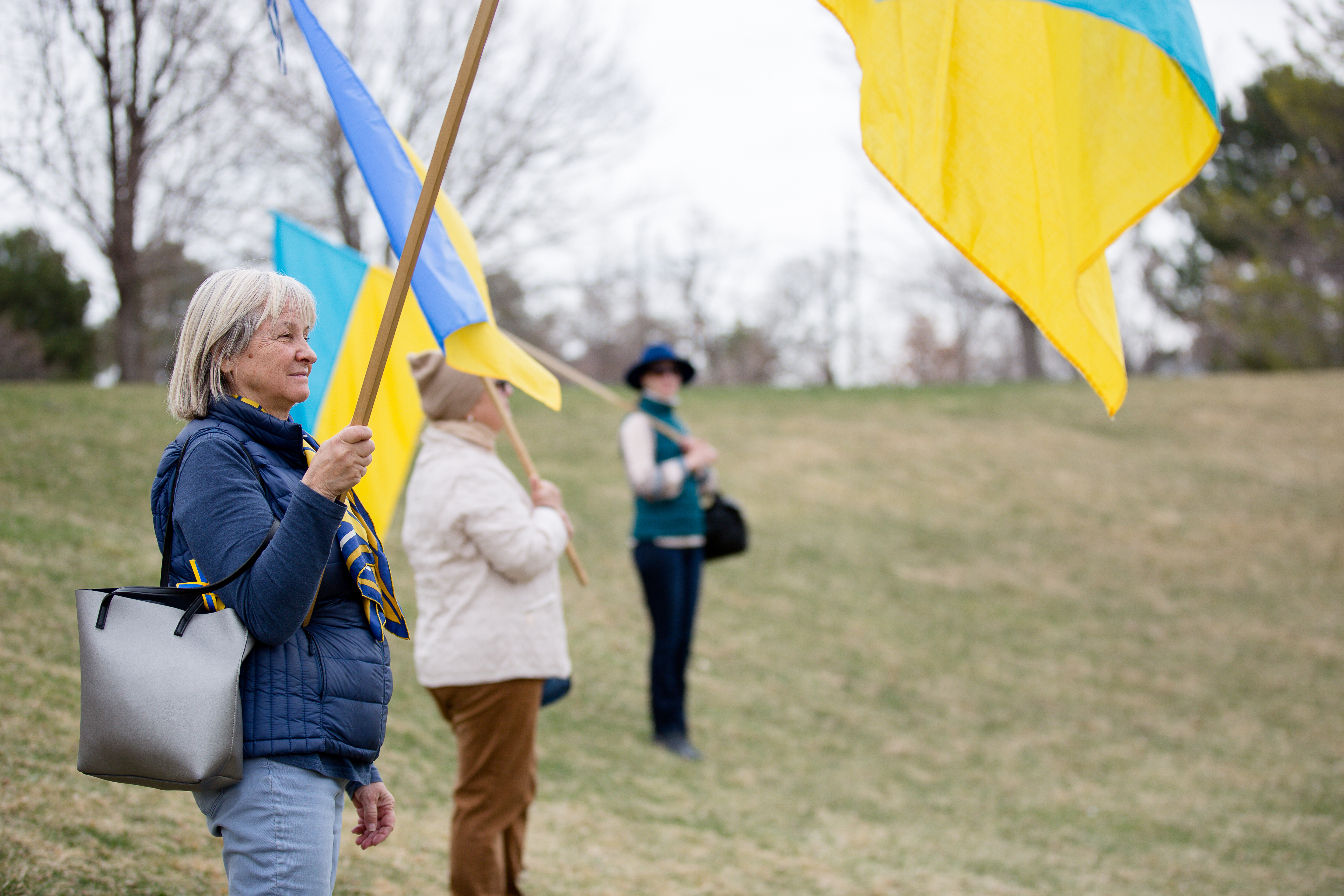 Odarka Figlus holds a Ukranian flag at an event in Babi Yar Park Sunday. The event, titled: Interfaith Gathering for Peace in Support of the Ukrainian People, was put together following President Zelensky's statement imploring people around the world to take to the streets, raise their voices and show support for Ukraine. March 27. ((Sara Hertwig/for The Denver Gazette))