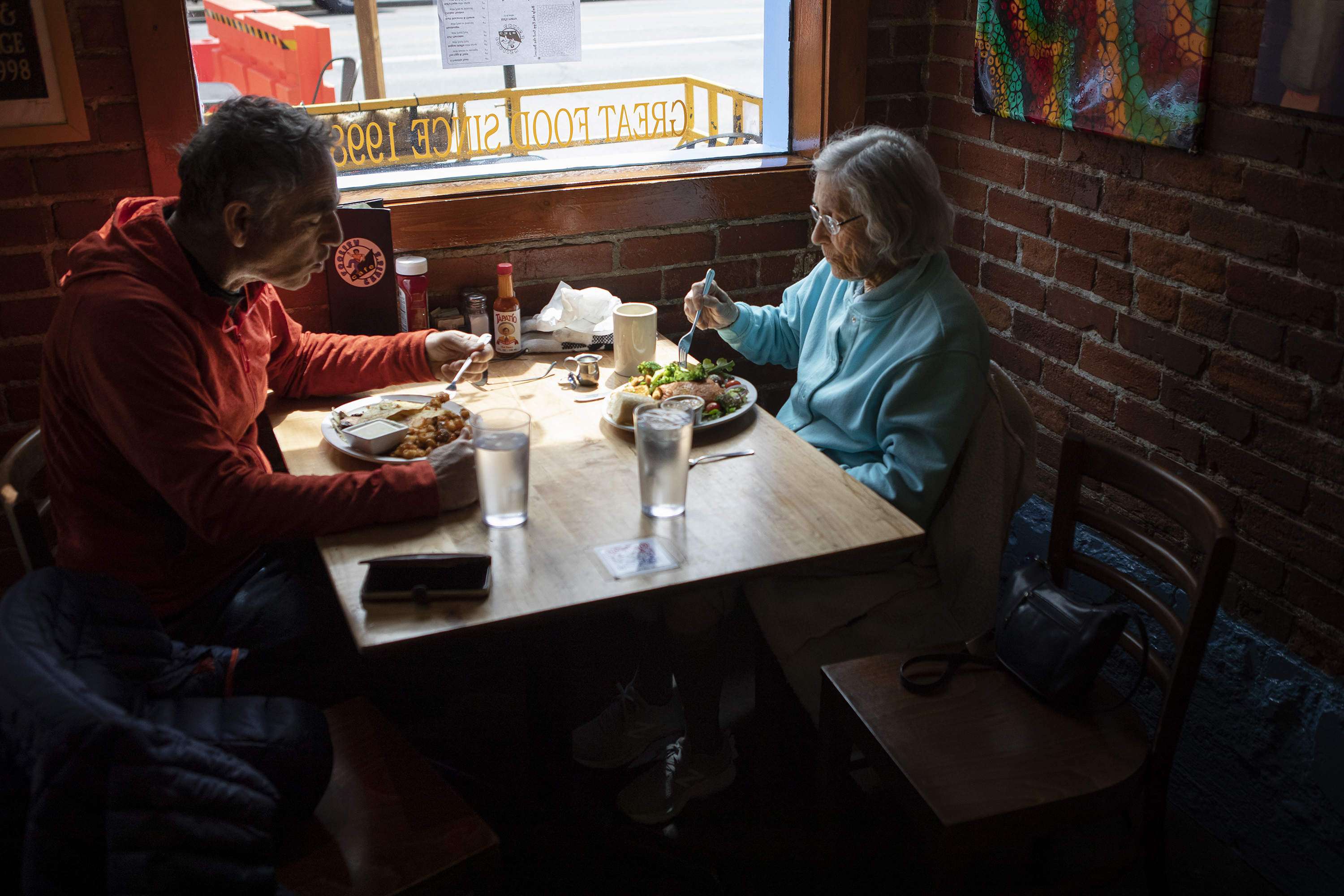 Judy Epstein and her son Rick Epstein enjoy lunch together on Wednesday, April 13, 2022, at Foolish Craig's Cafe in Boulder, Colo. (Timothy Hurst/The Denver Gazette) (Timothy Hurst)