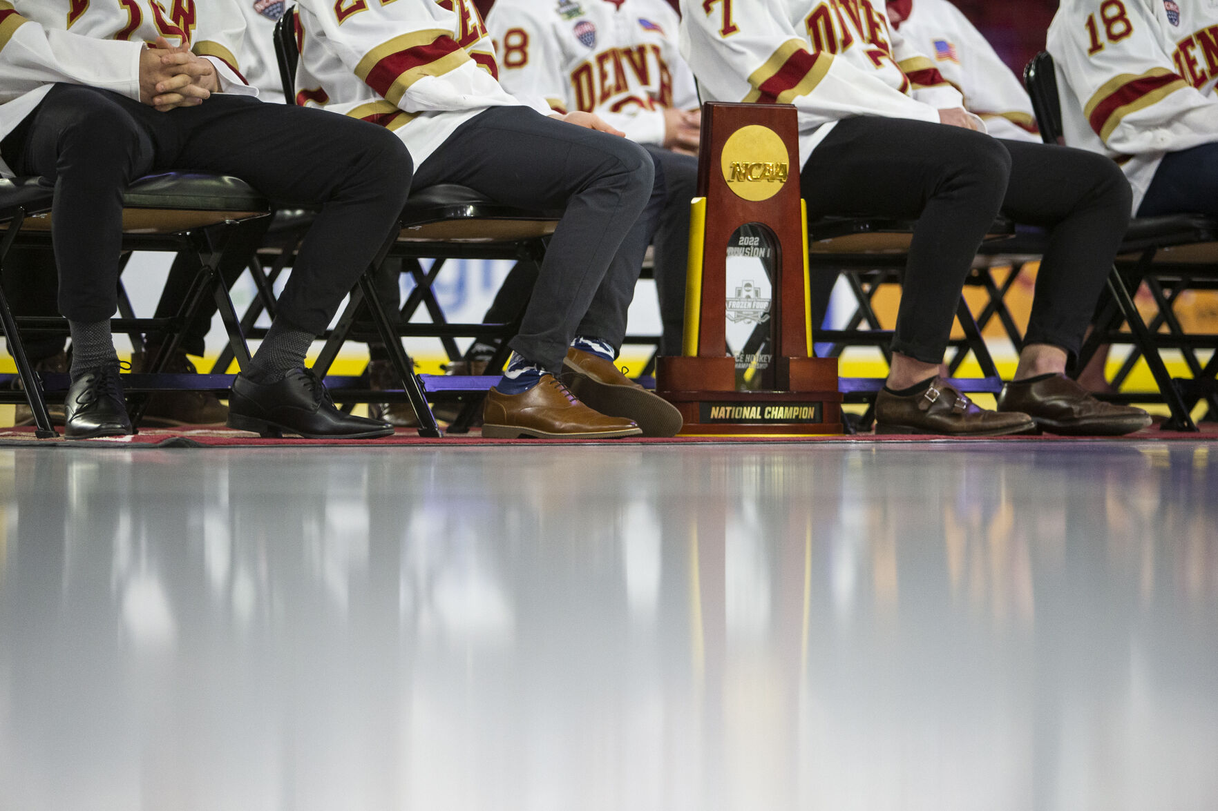 The University of Denver Men’s Hockey Team's national championship trophy sits at the players' feet during the 2022 National Championship Celebration on Tuesday, April 12, 2022, at Magness Arena in Denver, Colo. (Timothy Hurst/The Denver Gazette) (Timothy Hurst, The Denver Gazette)