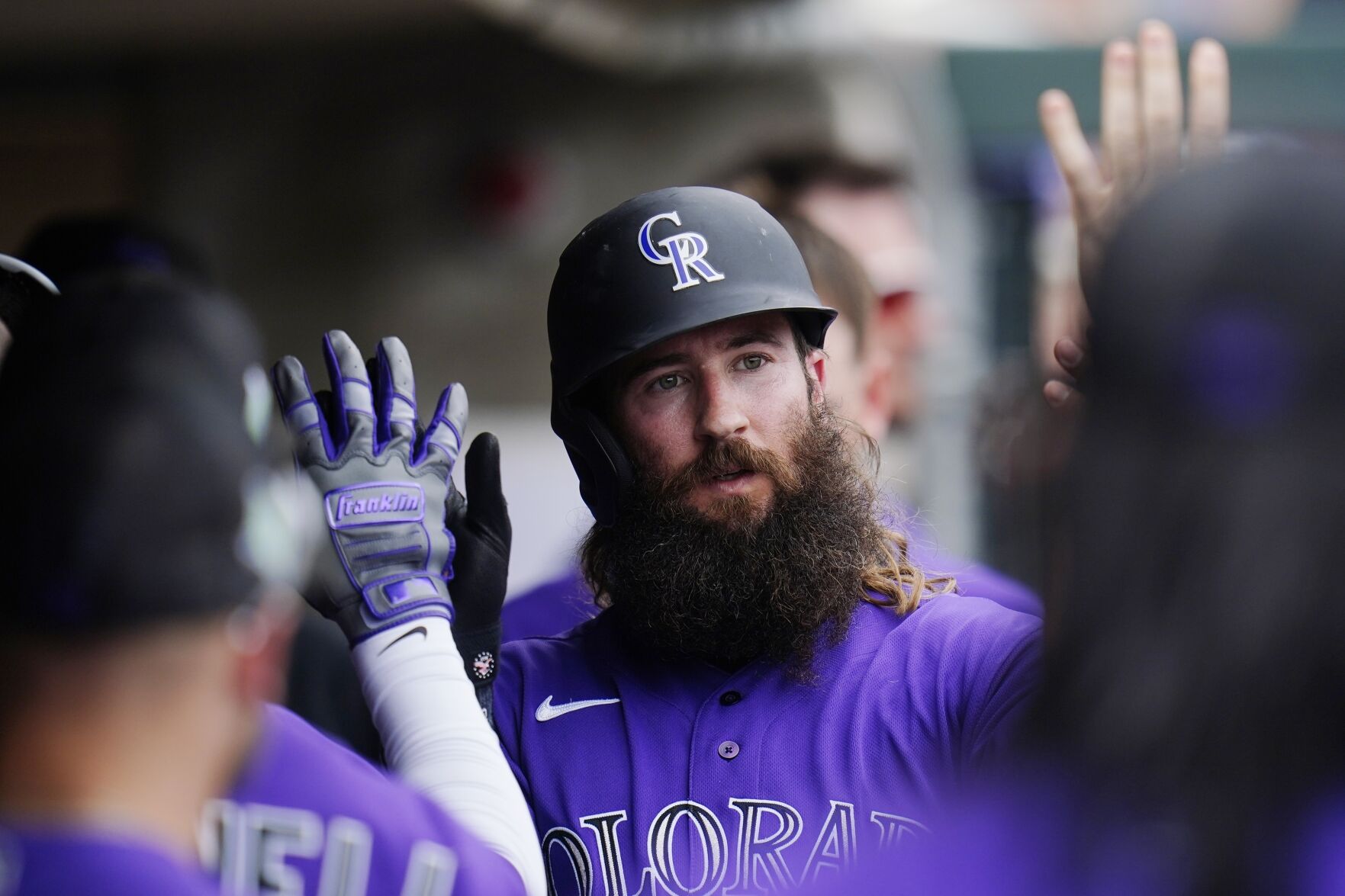 Colorado’s Charlie Blackmon celebrates after scoring a run Saturday against the Rangers during a spring training game in Scottsdale, Ariz. (The Associated Press)