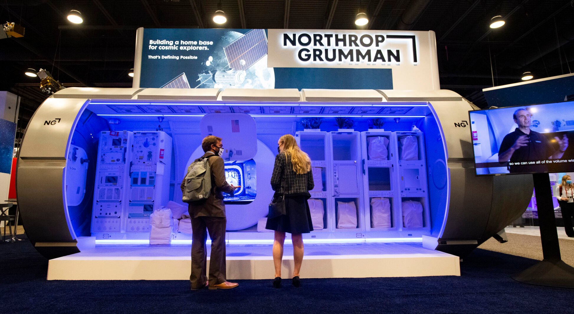 Anthony DeCicco of Northrop Grumman, left, and Sam Condie of Global Affairs Canada take a closer look that the Northrop Grumman display during the first day of the 36th Space Symposium last August at The Broadmoor. (Christian Murdock, Gazette file)
