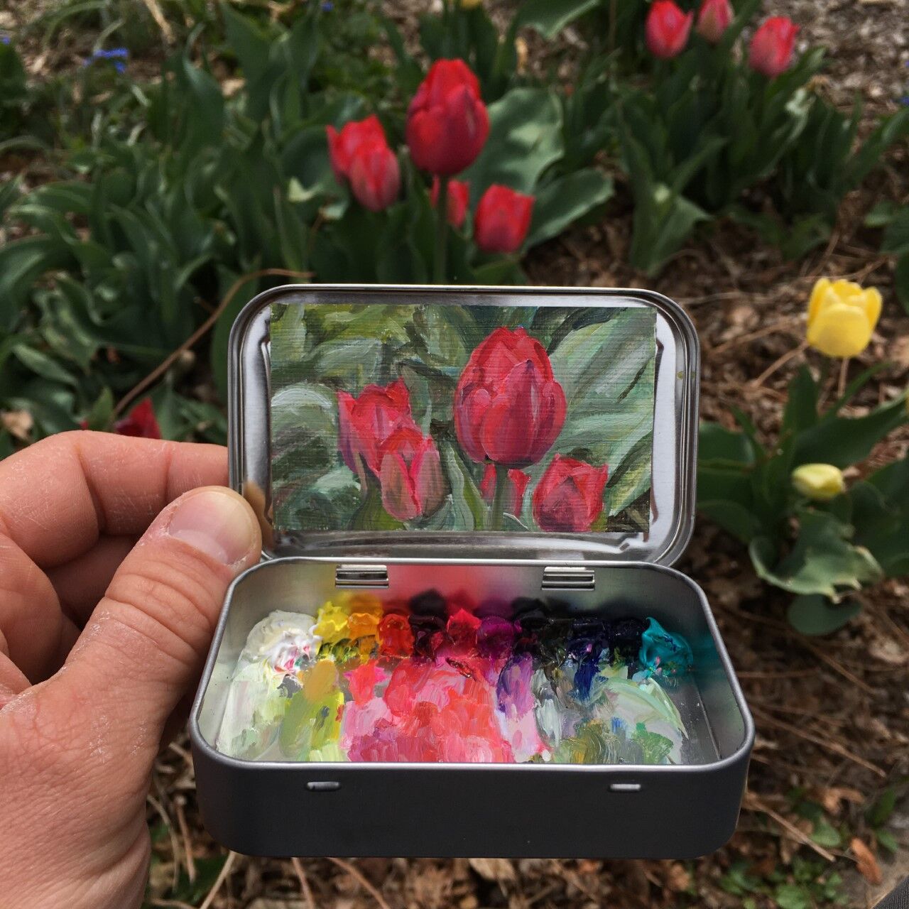 Remington Robinson, a Boulder artist, paints miniature plein air murals inside Altoids tins. (Contributed photo)