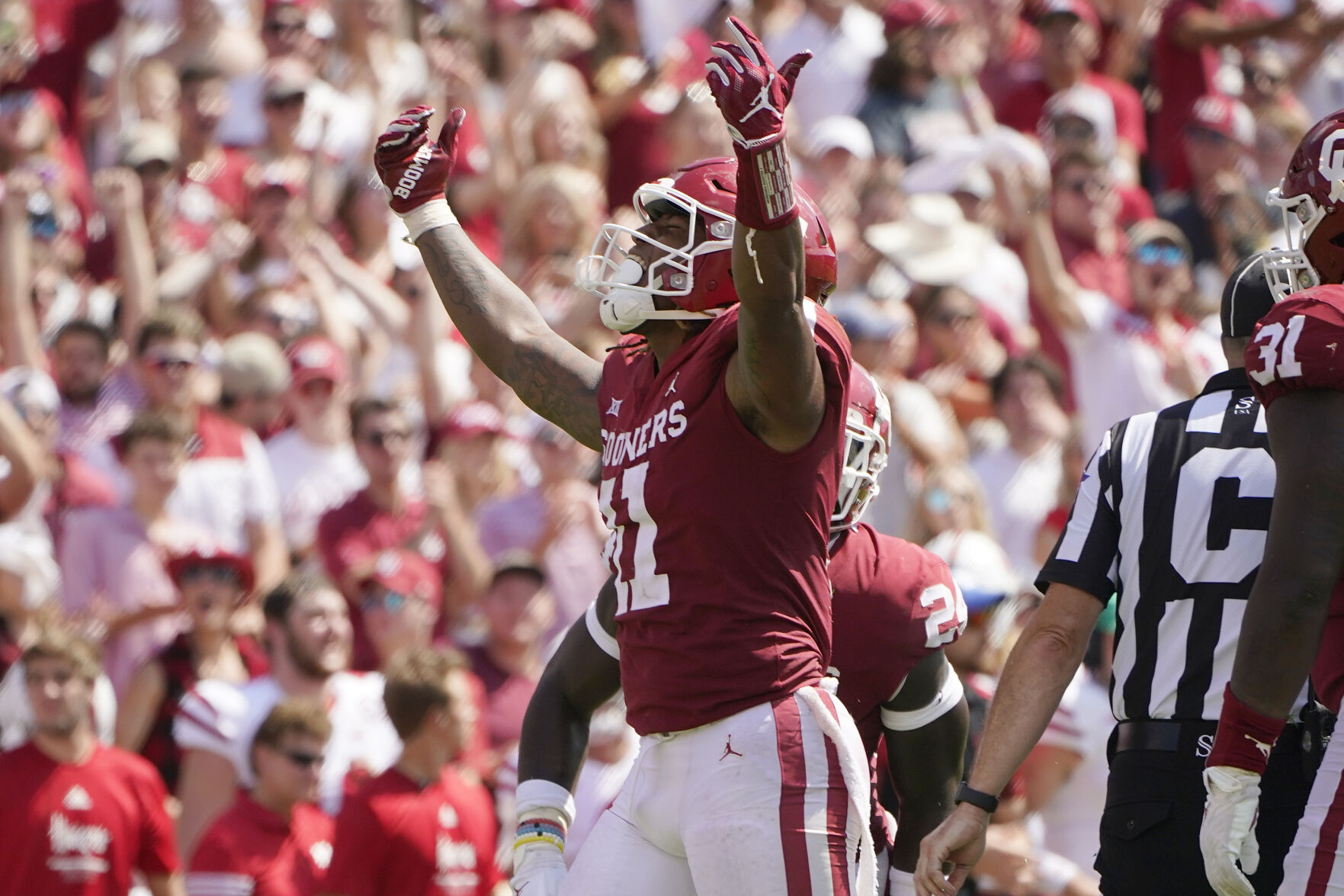 Oklahoma linebacker Nik Bonitto (11) gestures to fans after sacking Nebraska quarterback Adrian Martinez in the second half an NCAA college football game, Saturday, Sept. 18, 2021, in Norman, Okla. (AP Photo/Sue Ogrocki)