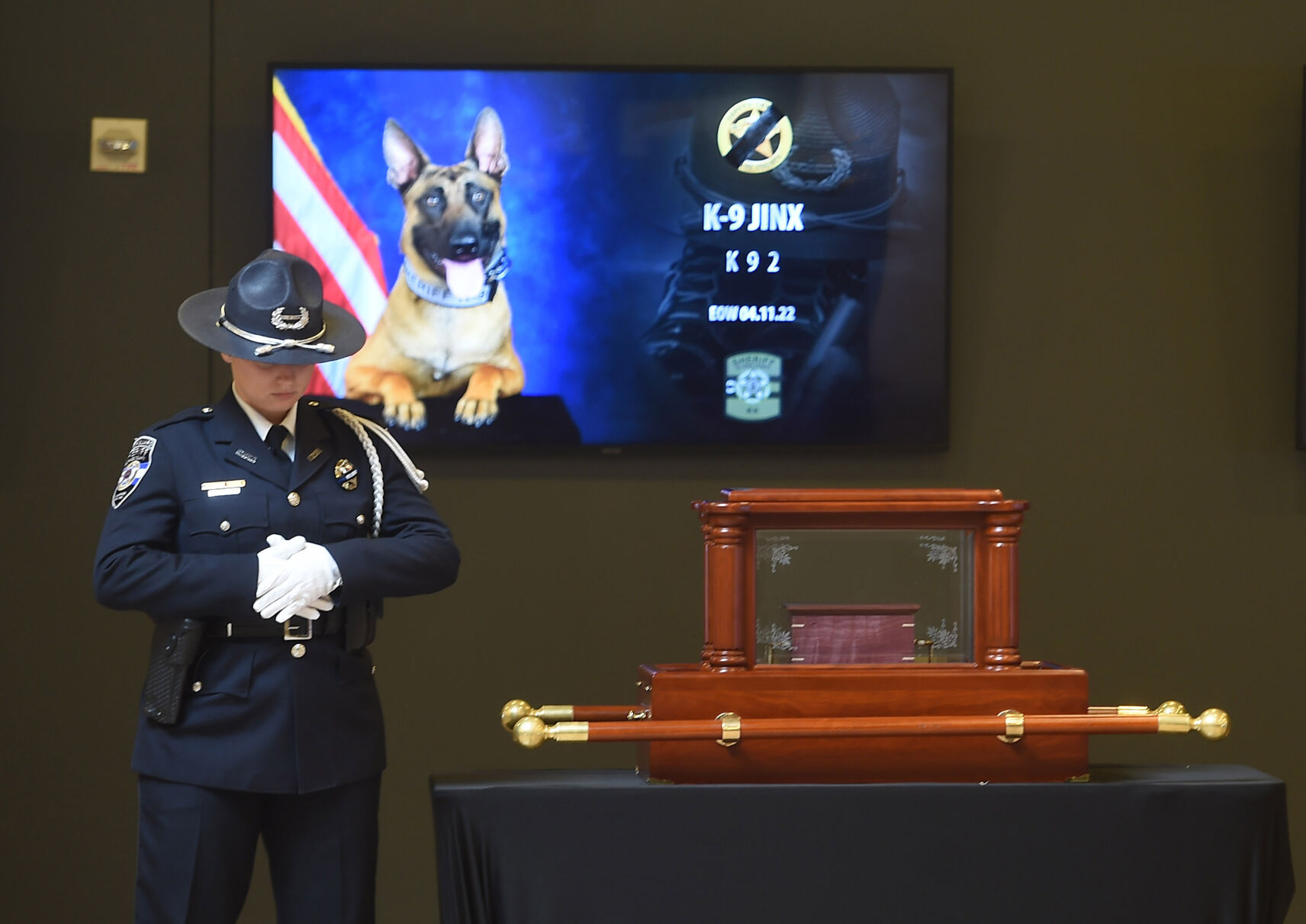 The remains of Jinx, an El Paso County Sheriff's Office K9, are guarded by a law enforcement officer during a 2-hour visitation before his memorial service. (Jerilee Bennett, The Gazette)