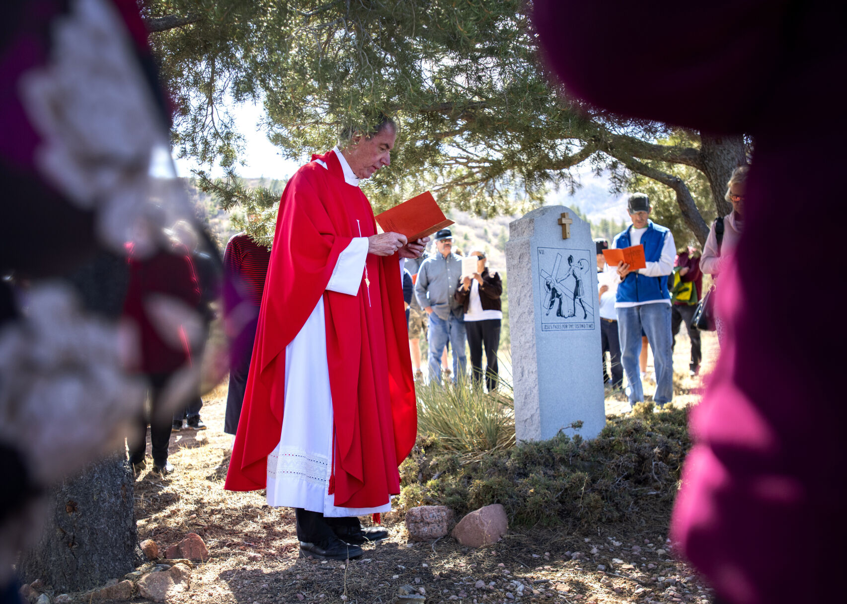 Father Ken Przybyla leads followers through the Stations of the Cross on Good Friday, April 15, 2022, at St. Francis of Assisi Parish in Colorado Springs. (The Gazette, Christian Murdock) (Christian Murdock/The Gazette)