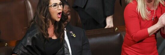 Rep. Lauren Boebert, R-Colo., left, and Rep. Marjorie Taylor Greene, R-Ga., right, scream