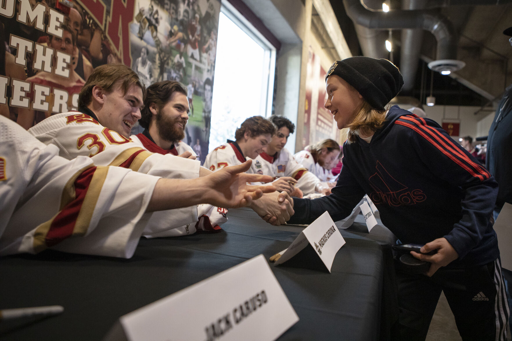 Junior Pioneers Goaltender Harrison Tate, 12, shakes hands with his idol, University of Denver junior goaltender Magnus Chrona (30) during the 2022 National Championship Celebration on Tuesday, April 12, 2022, at Magness Arena in Denver, Colo. (Timothy Hurst/The Denver Gazette) (Timothy Hurst, The Denver Gazette)