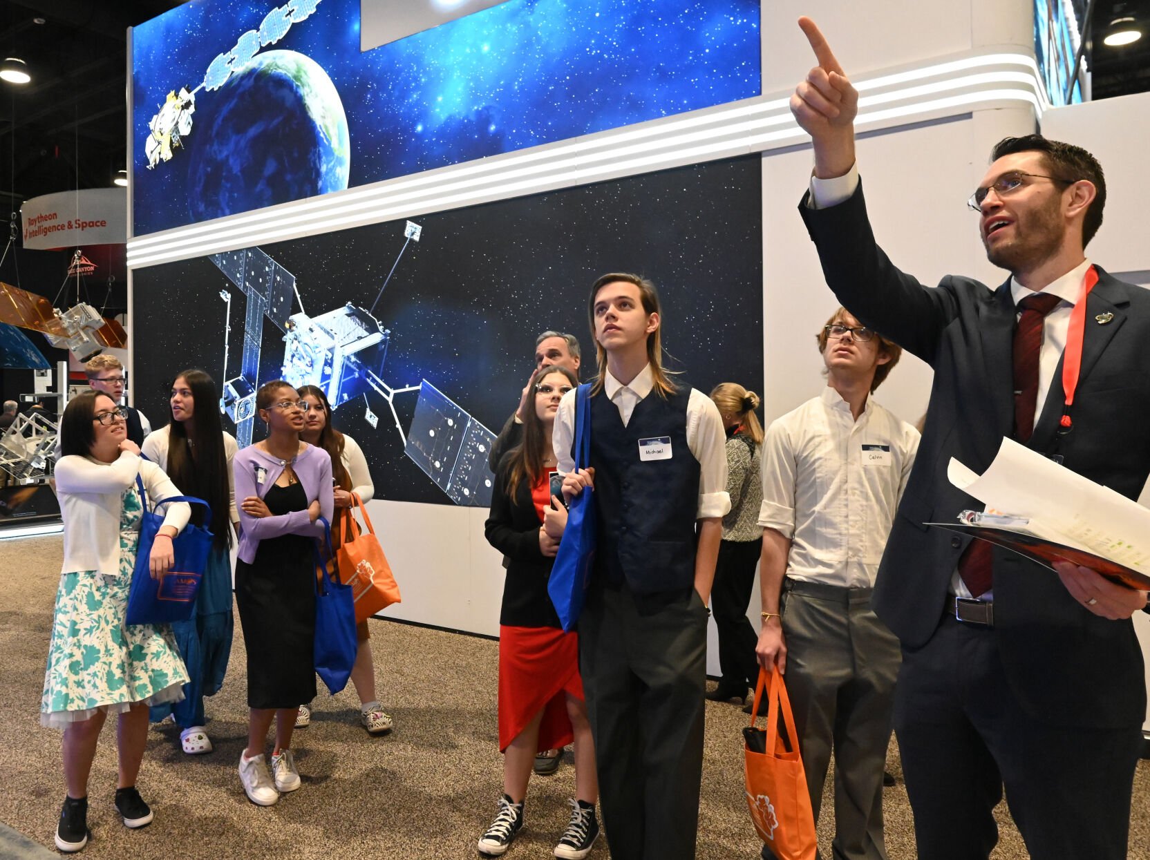 Students from Mitchell High School were some of the STEM students that were touring the exhibits on the last day of the 37th Space Symposium on Thursday, April 7, 2022. They were being given the tour by Jeffrey Schloemer (right) with Lockheed Martin. (Photo by Jerilee Bennett, The Gazette) (Jerilee Bennett, The Gazette)