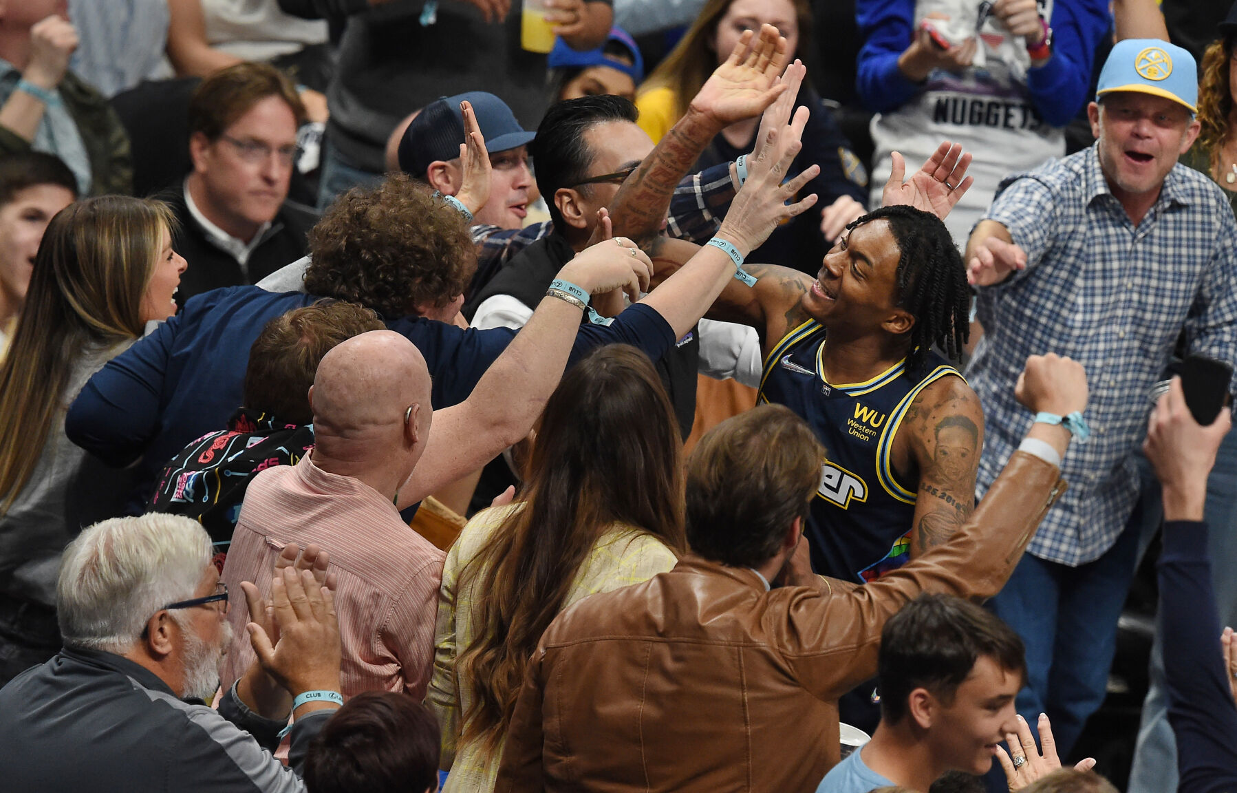 Nuggets Rookie Bones Hyland goes over to high five with the crowd after hitting his third 3-pointer in a row in the second quarter of game 4. The Nuggets avoided elimination in the first round of the NBA playoffs at Ball Arena on Sunday, April 24, 2022 by beating the Golden State Warriors 126-121. (Photo by Jerilee Bennett, The Gazette) (Jerilee Bennett)