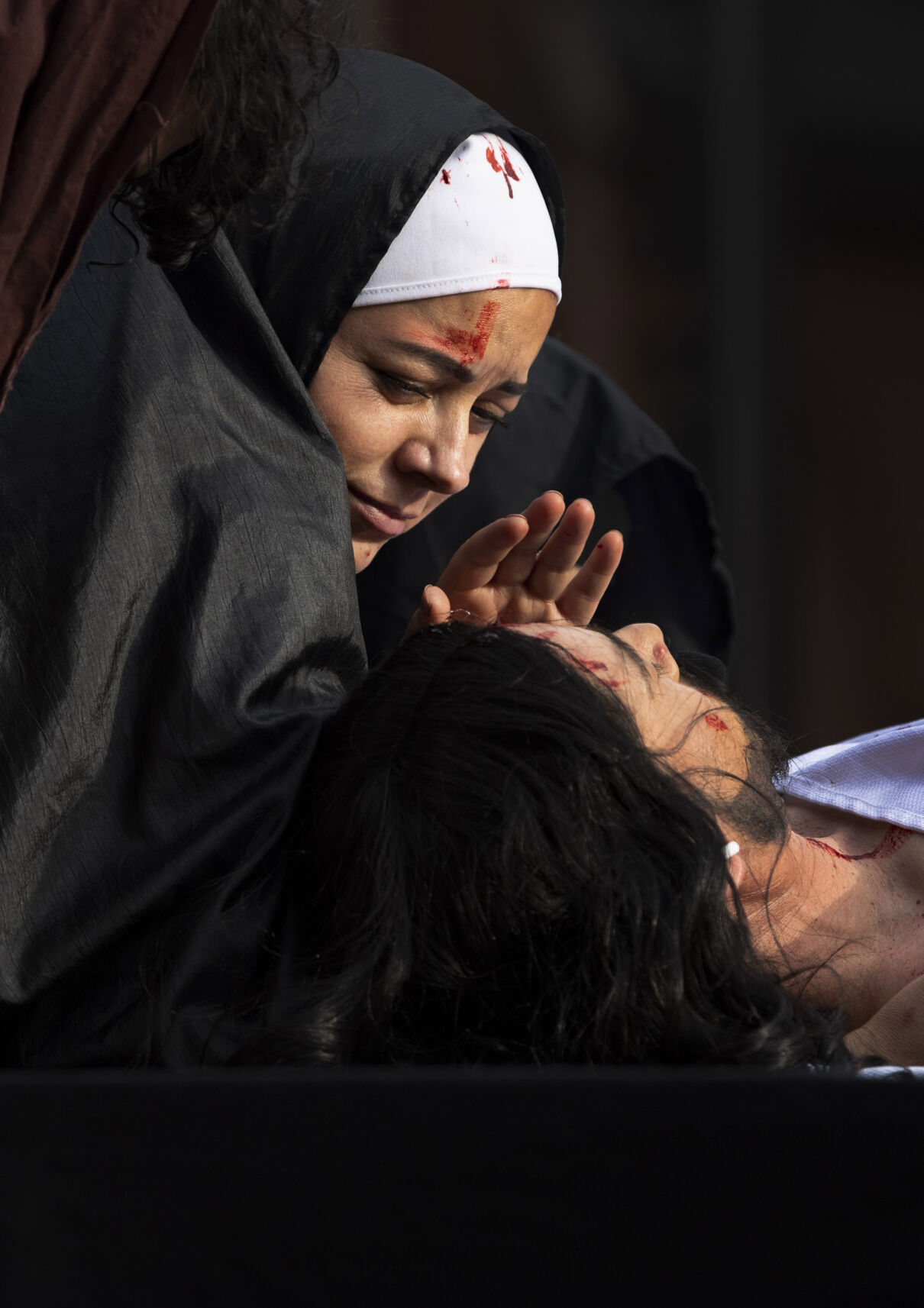 Mary the mother of Jesus, played by Lety Rios, cries over the dead body of her son, played by Samuel Romero, during the Via Crucis performance at St. Mary’s Cathedral on Good Friday, April 15, 2022. Members of the Catholic church’s hispanic ministries acted out the Stations of the Cross in Spanish as part of the Easter celebration. (The Gazette, Christian Murdock) (Christian Murdock/The Gazette)