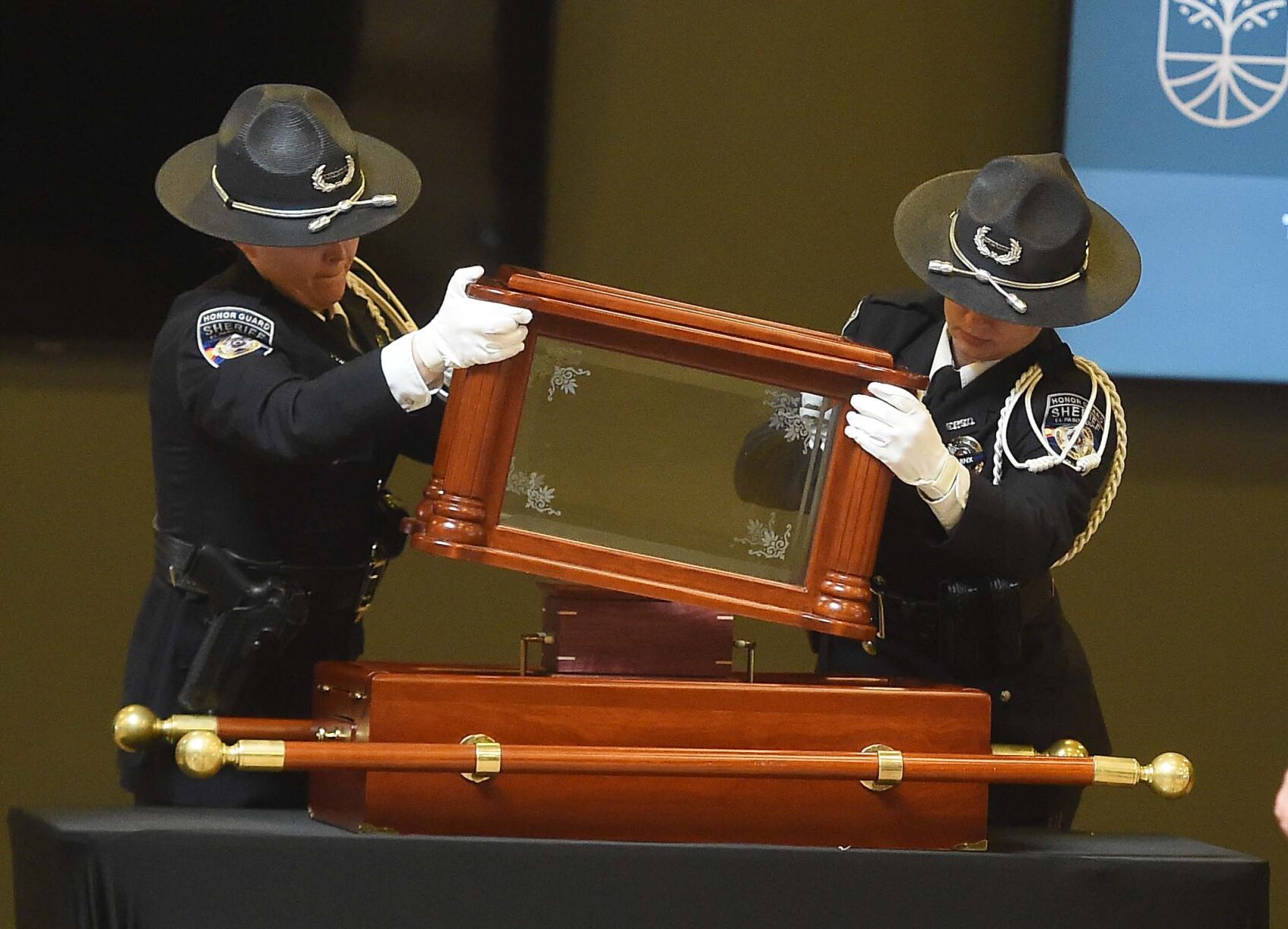 The remains of K9 Jinx are covered by law enforcement officers. (Jerilee Bennett, The Gazette)