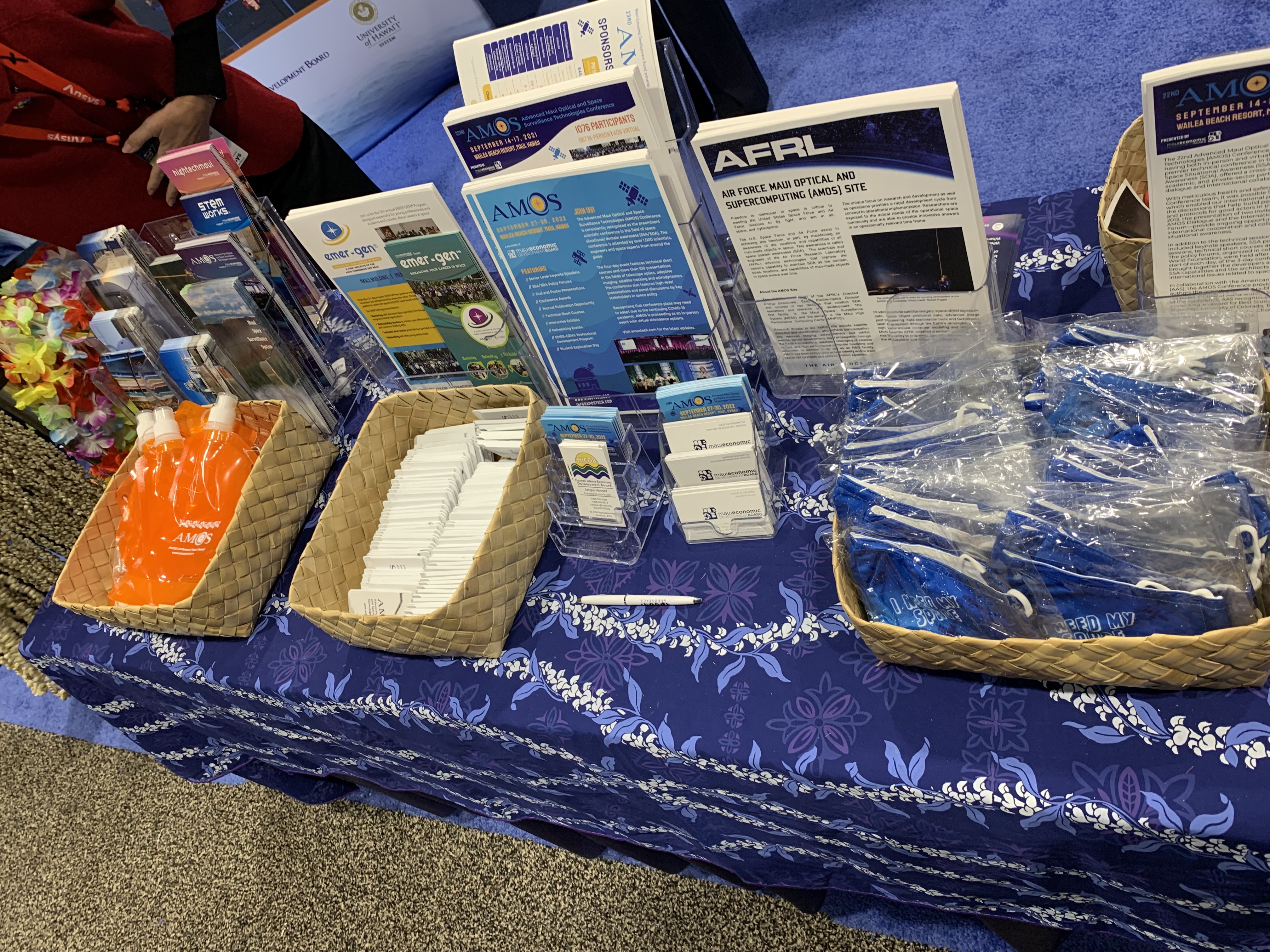 The Maui Economic Development Board handed out swag promoting the AMOS Conference (Advanced Maui Optical and Space Surveillance Technologies) in September at its booth at the 37th Space Symposium in Colorado Springs last week. (BY DENNIS HUSPENI/THE DENVER GAZETTE)