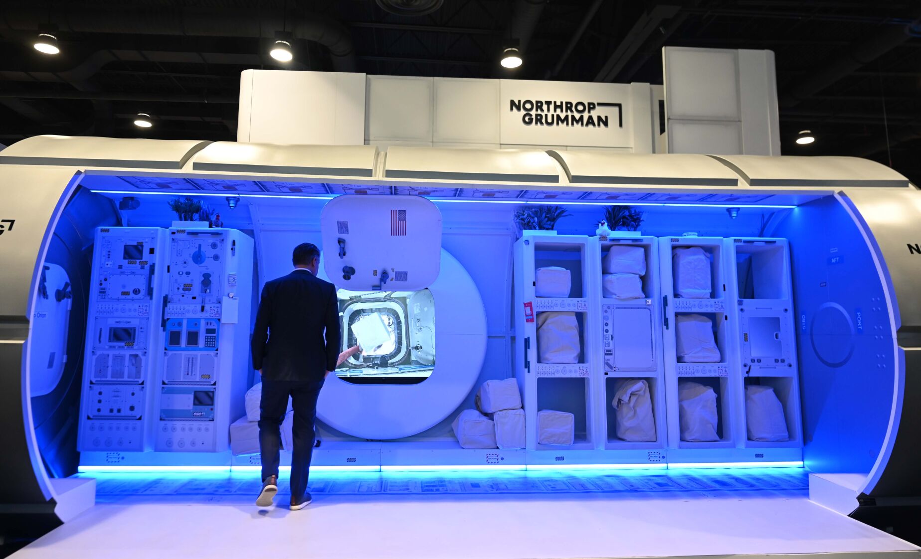 A Space Symposium attendee walks into a mockup of HALO at the Northrop Grumman during the first evening of the 37th Space Symposium. HALO is where astronauts will live and conduct research while visiting the Gateway. The 37th Space Symposium kicked off Monday evening at the Broadmoor on Monday, April 4, 2022. (Photo by Jerilee Bennett, The Gazette) (Jerilee Bennett)