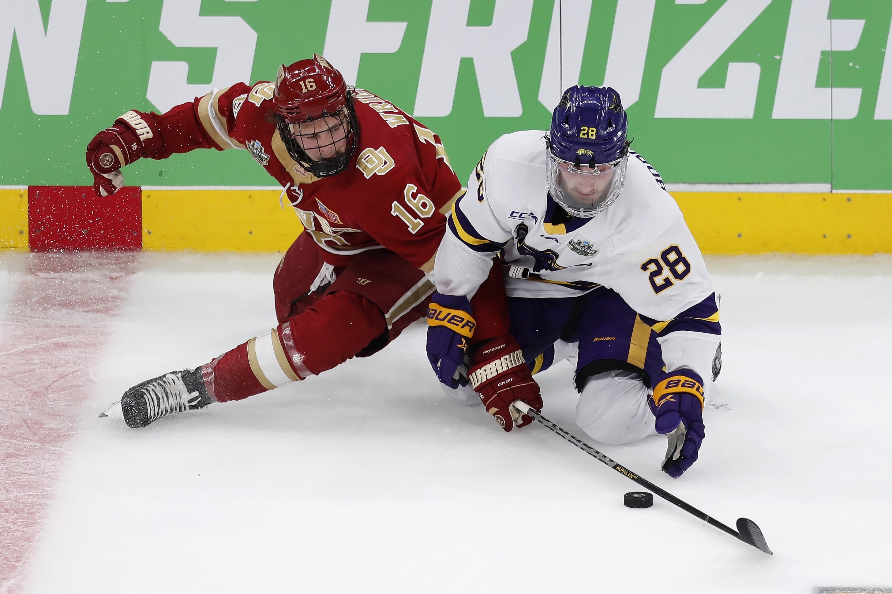 Denver’s Cameron Wright, left, and Minnesota State’s Cade Borchardt compete for the puck during the second period Saturday, in Boston. (The Associated Press)