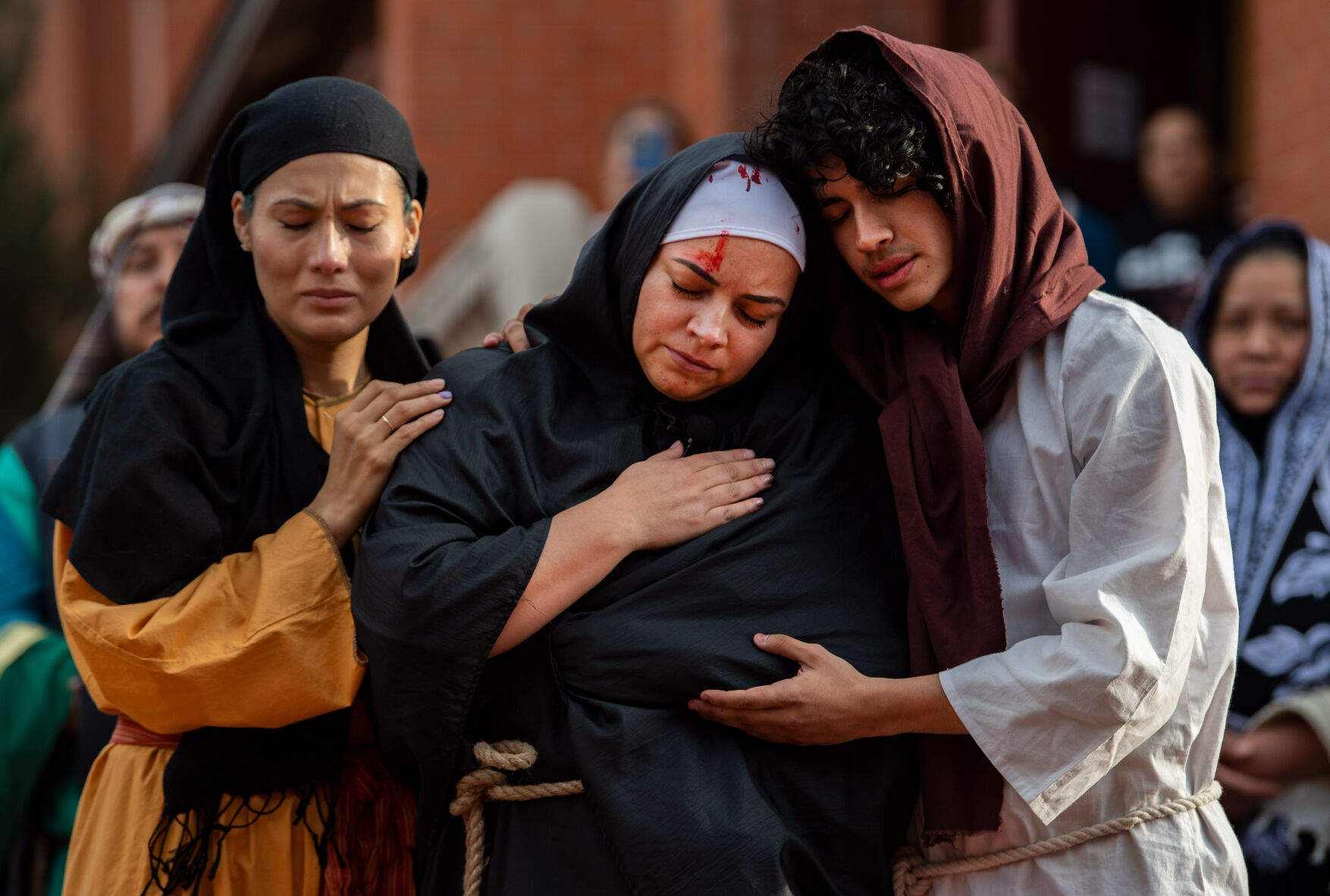 John the Apostle, played by Jesus Sanchez, holds Mary, played by Lety Rios, while Mary Madalene, played by Anabelle Rivera, joins them as they weep next to Jesus on the cross during the Via Crucis performance at St. Mary’s Cathedral on Good Friday, April 15, 2022. Members of the Catholic church’s hispanic ministries acted out the Stations of the Cross in Spanish as part of the Easter celebration. (The Gazette, Christian Murdock) (The Gazette, Christian Murdock) (Christian Murdock/The Gazette)