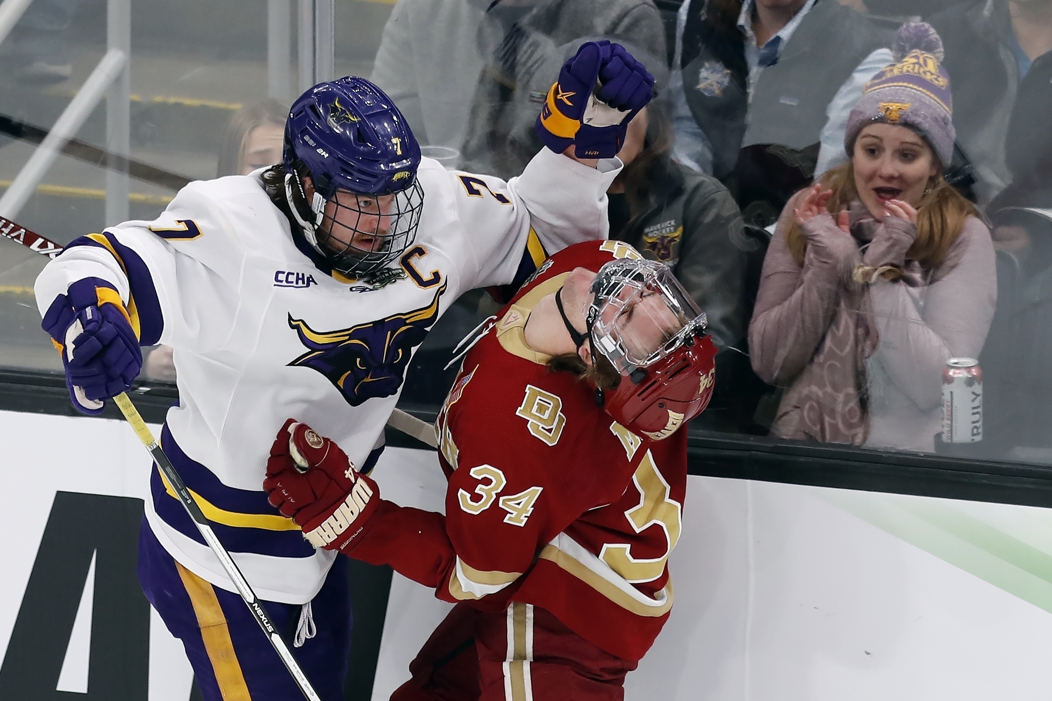 Minnesota State’s Wyatt Aamodt, left, and Denver’s Carter Mazur battle along the boards during the first period of the Frozen Four championship game Saturday in Boston.