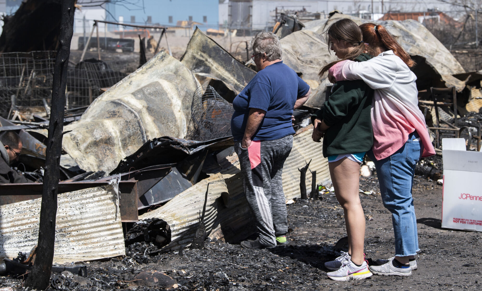 Chandra Campos hugs her daughter Alyssa, 14, as they search through the remains of their home. (Christian Murdock, The Gazette)
