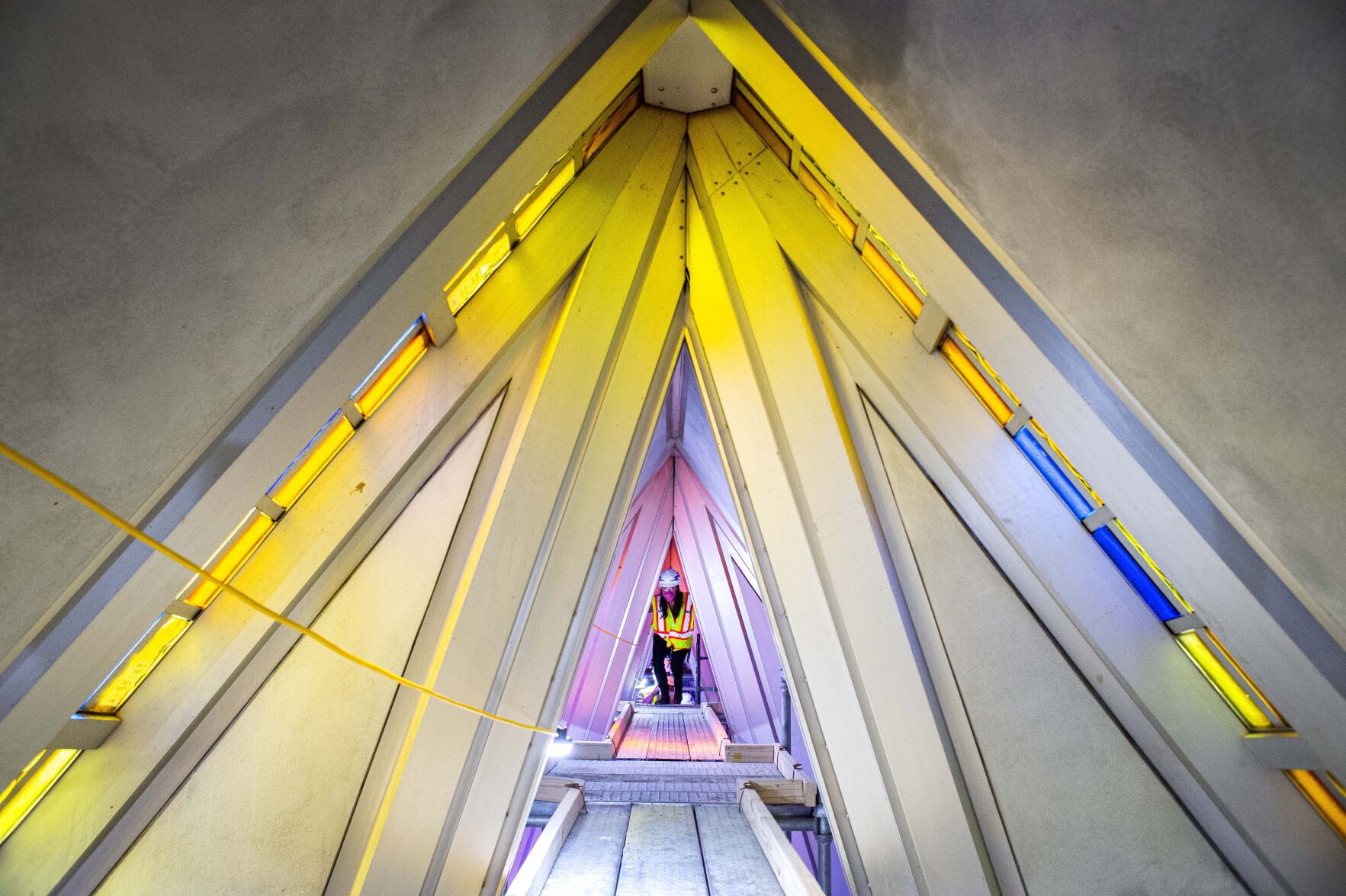Air Force Academy architect Daniela Lawrence climbs the scaffolding to the top of the 150-foot U.S. Air Force Academy Cadet Chapel Friday, Aug. 7, 2020, while touring the the chapel restoration with a group from the Denver Modernism Week. More than 50 semi-truck were used to deliver all the inside scaffolding that will allow crews to catalog and restore all the aluminum panels and stained glass. The chapel designed by American Architect Walter Netsch was named a U.S. National Historic Landmark in 2004. (Christian Murdock, The Gazette)