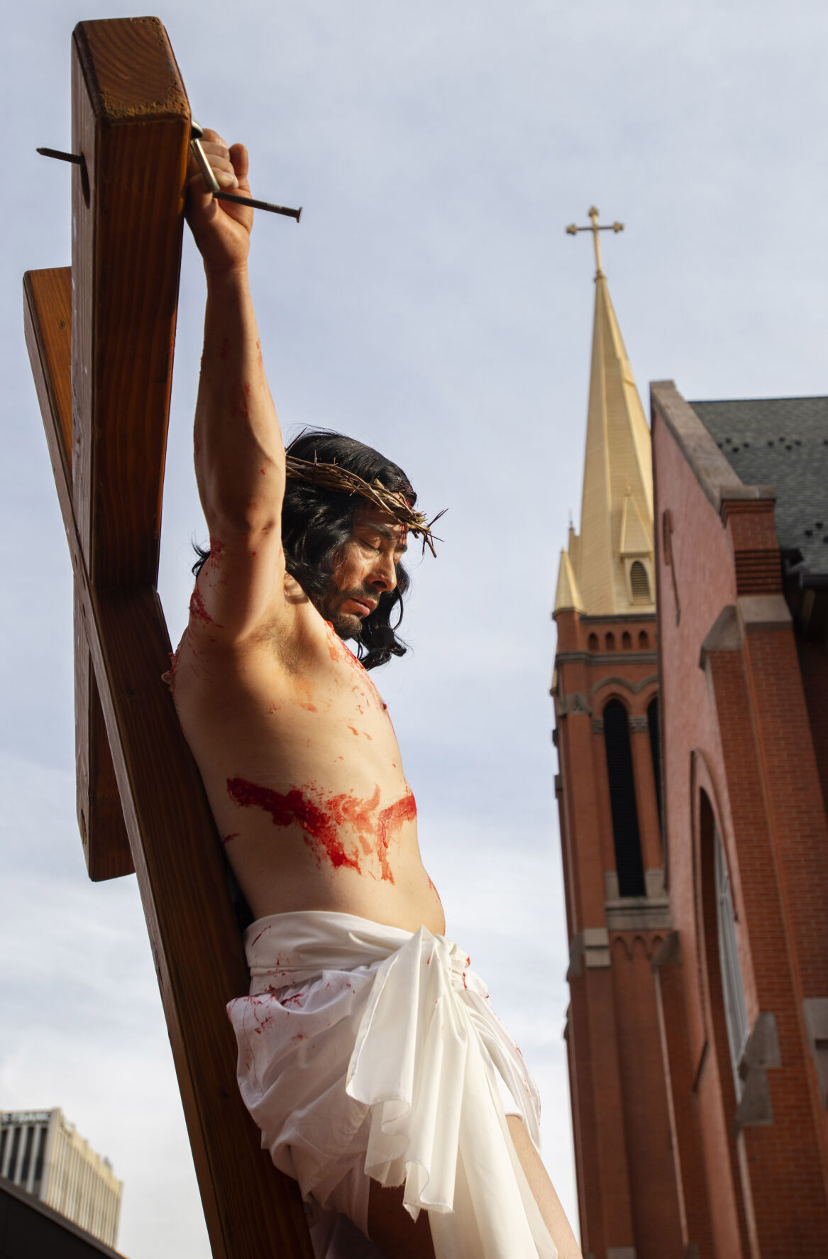 Jesus, played by Samuel Romero, dies on the cross during the Via Crucis performance at St. Mary’s Cathedral on Good Friday, April 15, 2022. Members of the Catholic church’s hispanic ministries acted out the Stations of the Cross in Spanish as part of the Easter celebration. (The Gazette, Christian Murdock) (Christian Murdock/The Gazette)