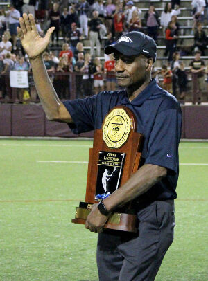 Tom Robinson presents the 2017 girls 5A state lacrosse championship trophy at the University of Denver. (Photo courtesy CHSAA)