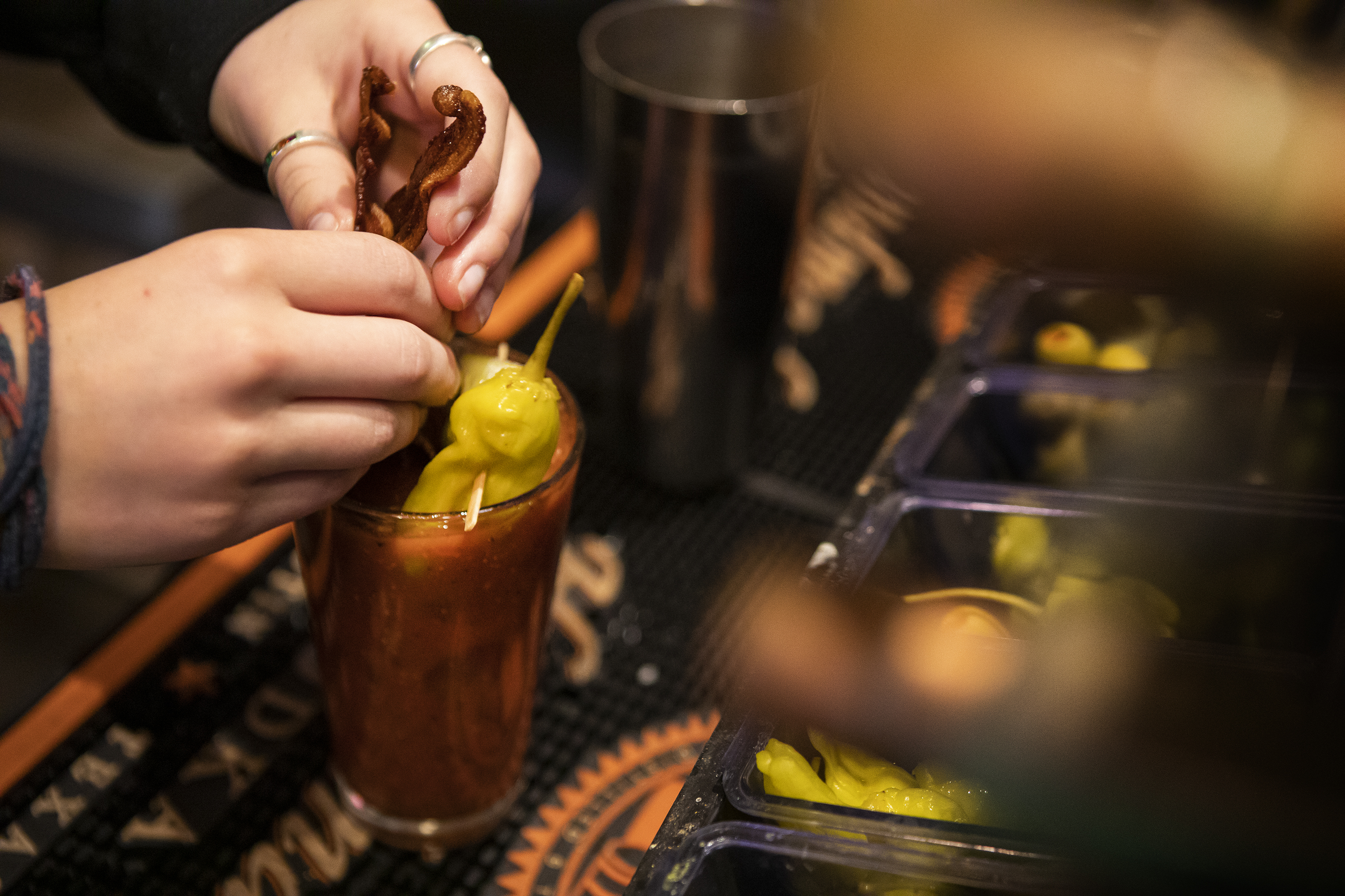Two slices of bacon are the finishing touch to a House Infused Bloody Mary on Wednesday, April 13, 2022, at Foolish Craig's Cafe in Boulder, Colo. (Timothy Hurst/The Denver Gazette) (Timothy Hurst)