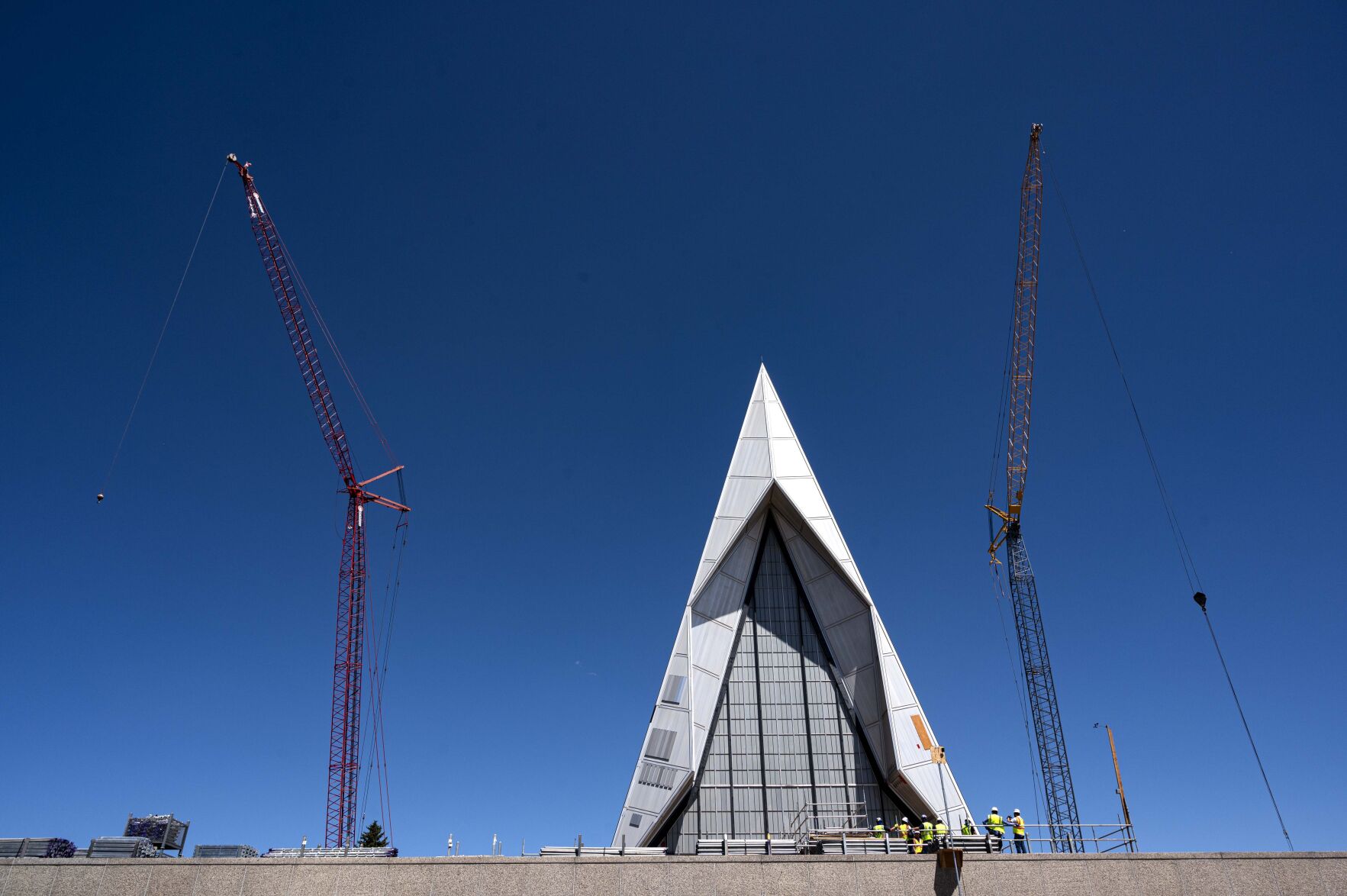 A group from the Denver Modernism Week conference stand outside the U.S. Air Force Academy Cadet Chapel Friday, Aug. 7, 2020, as they tour the $158-million restoration and renovation project of the 1962 chapel to learn about Saving Modernism History. Campus Architect Duane Boyle gave the tour. (Christian Murdock, The Gazette)