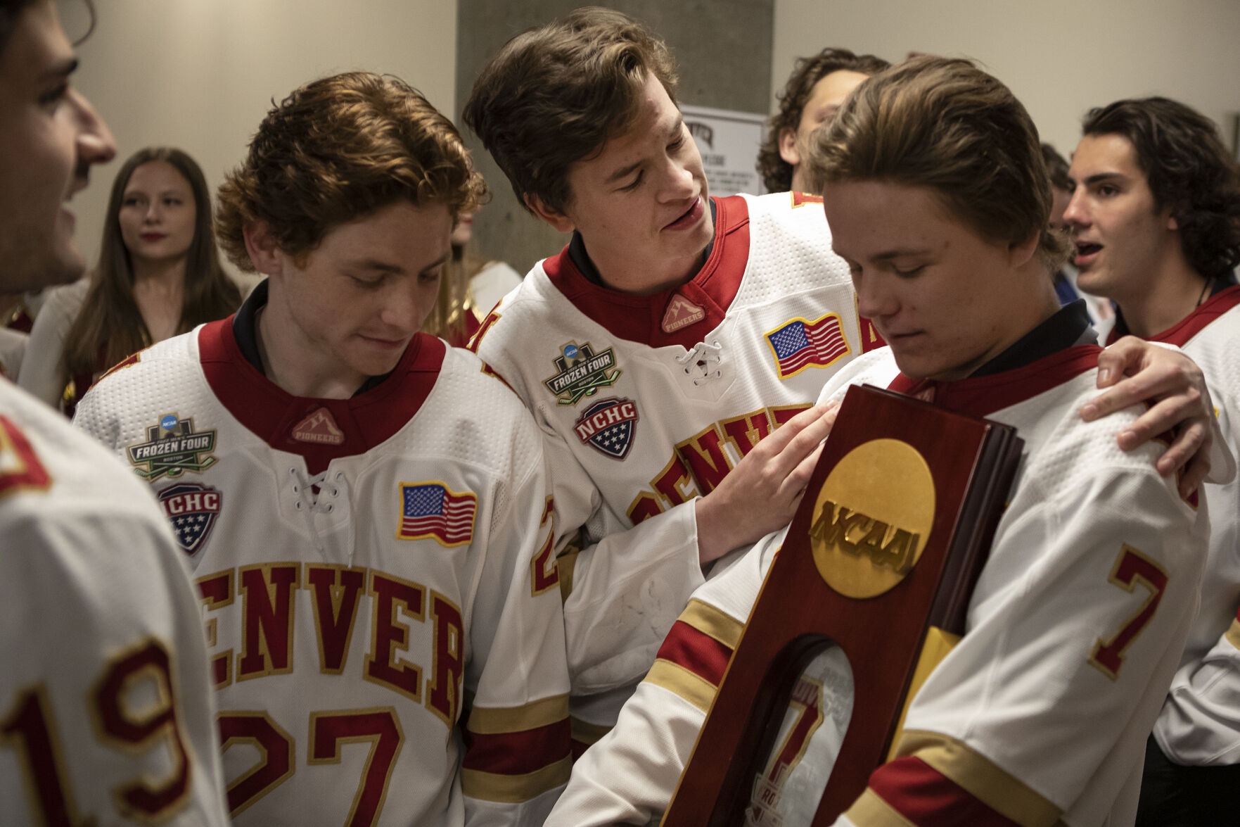 University of Denver senior forward Ryan Barrow (18) talks to fellow senior forward Brett Stapley (7) as he holds the NCA Nation Championship trophy during the 2022 National Championship Celebration on Tuesday, April 12, 2022, at Magness Arena in Denver, Colo. (Timothy Hurst/The Denver Gazette) (Timothy Hurst, The Denver Gazette)