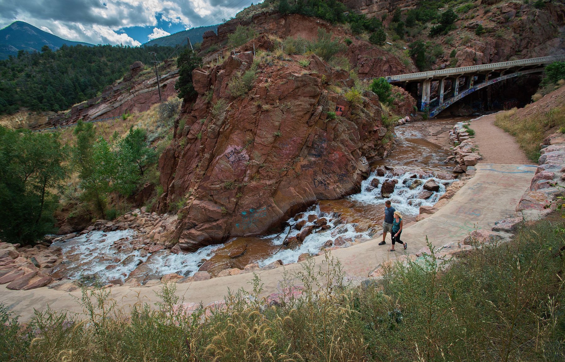 Dawn Hansen of Manitou Springs and Monte Hoover of Flagstaff, Ariz., walk along the path to Rainbow Falls in Manitou Springs on Tuesday, Sept. 7, 2015. (Christian Murdock, The Gazette)