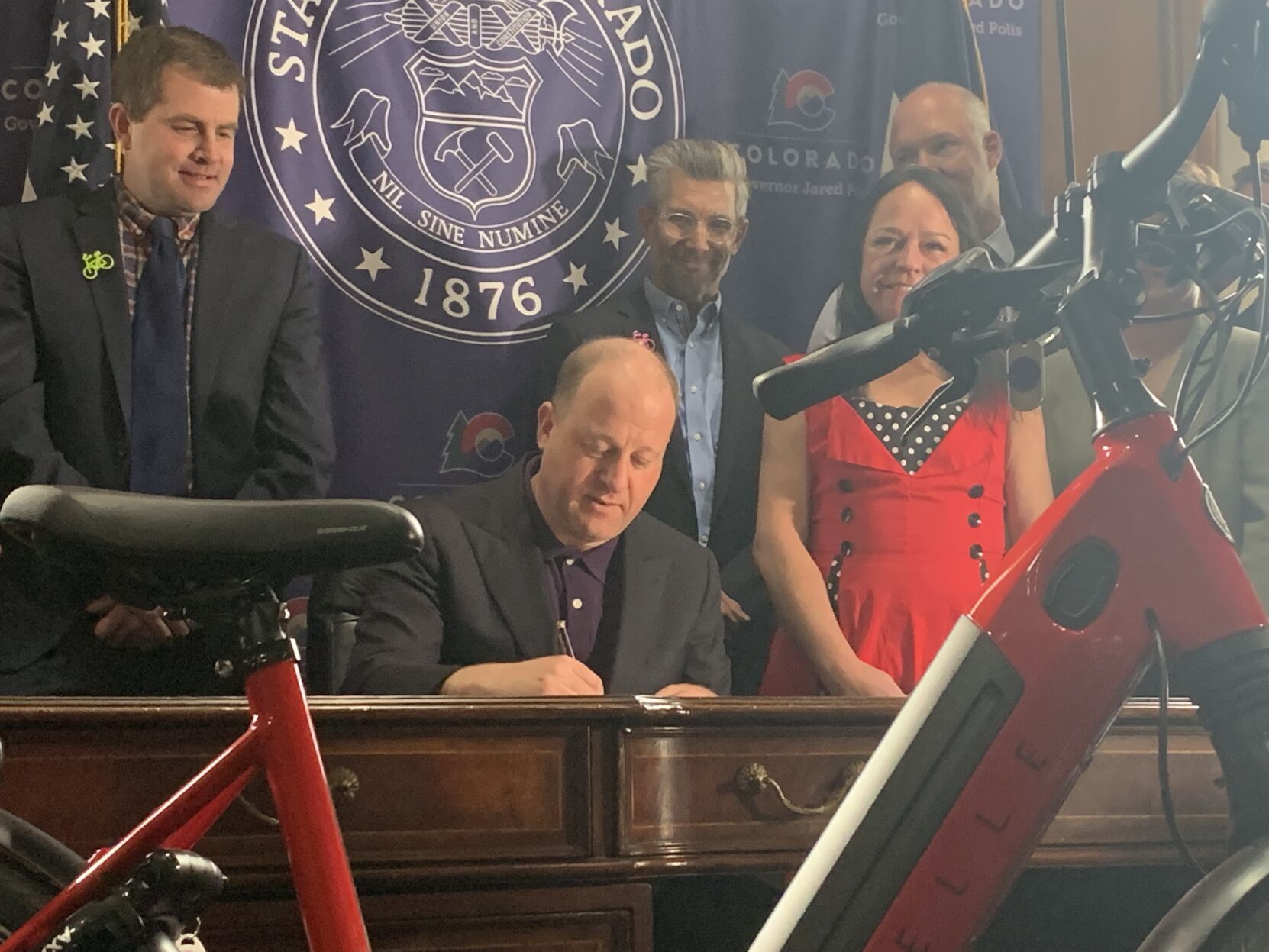 Gov. Jared Polis signs HB 1028, the statewide