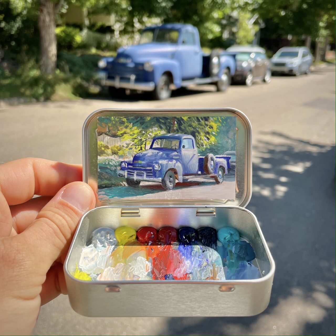 Remington Robinson, a Boulder artist, paints miniature plein air murals inside Altoids tins. (Contributed photo)