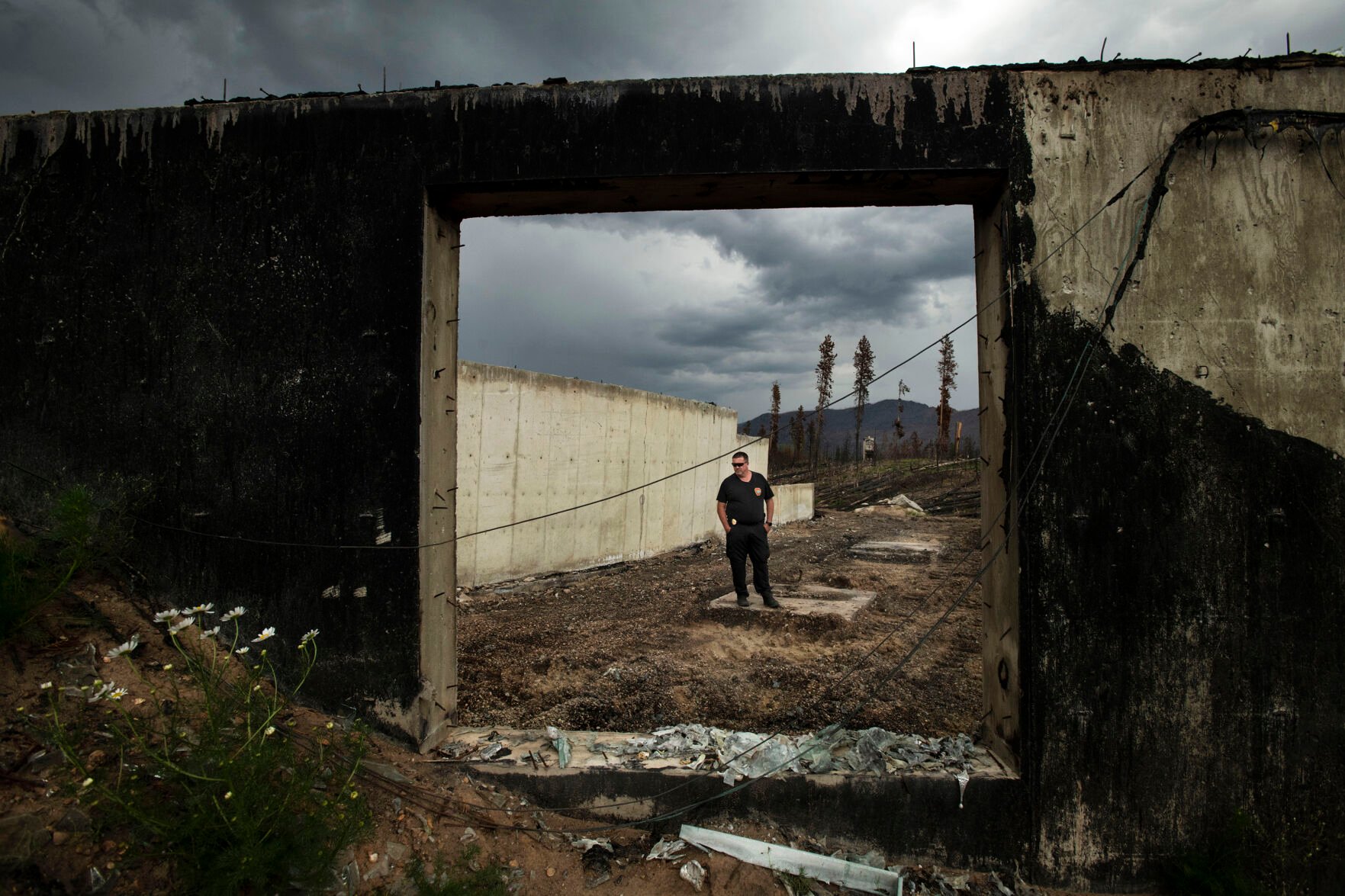 Dan Mayer, the fire marshal for the Grand Lake Fire Protection District, stands inside the remnants of a home located behind the Grand Lake Fire Protection Station 2 in Grand Lake, Colo., on July 22, 2021. Last October the East Troublesome Fire burned a total of 193,812 acres, becoming the second largest fire in Colorado history. (Chancey Bush/ The Gazette) (Chancey Bush/ The Gazette)
