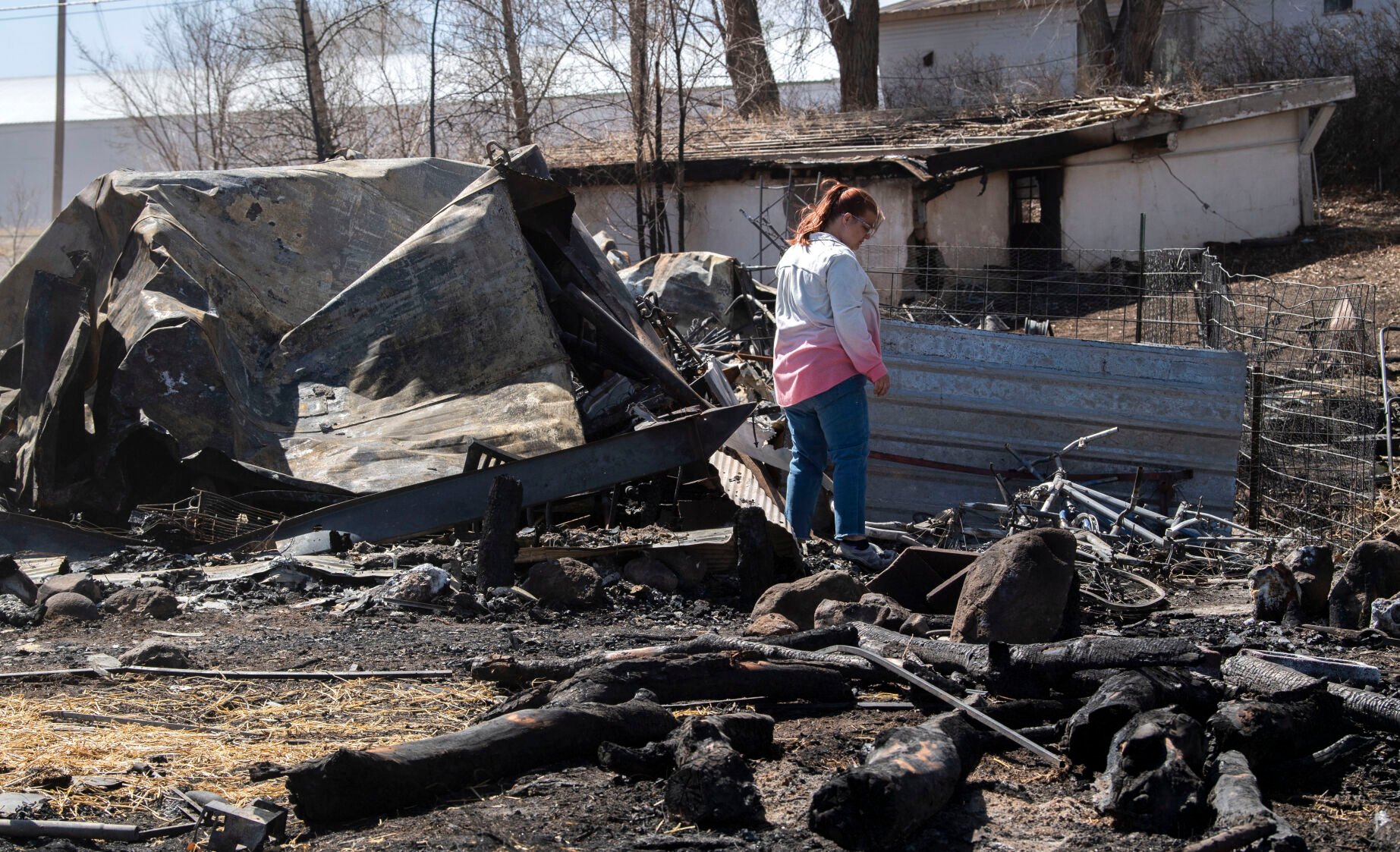 Chandra Campos searches through the remains of their home in Monte Vista on Friday. A fire fueled by high winds Wednesday burned 17 structures and displaced six families. Campos and her family lost most of their belongings. (Christian Murdock, The Gazette)