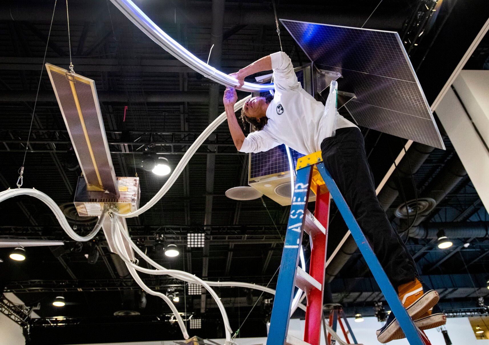 Chris Williams works on the Lockheed Martin display for the 36th Space Symposium on Aug. 20, 2021, inside The Broadmoor’s new Bartolin Hall. (Christian Murdock, Gazette file)