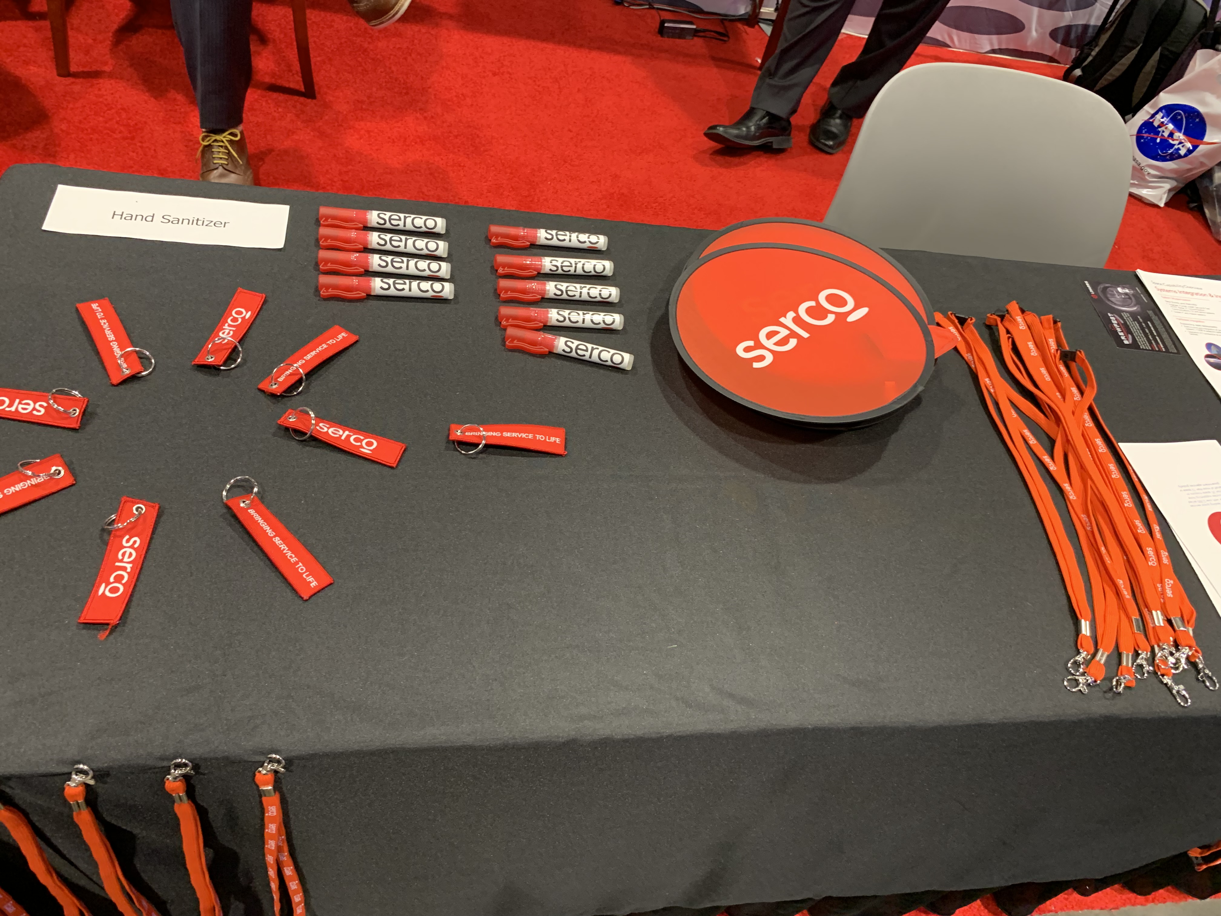 The Serco booth at the 37th Space Symposium in Colorado Springs last week. The collapsible frisbee/fan was a popular swag item. (DENNIS HUSPENI/THE DENVER GAZETTE)