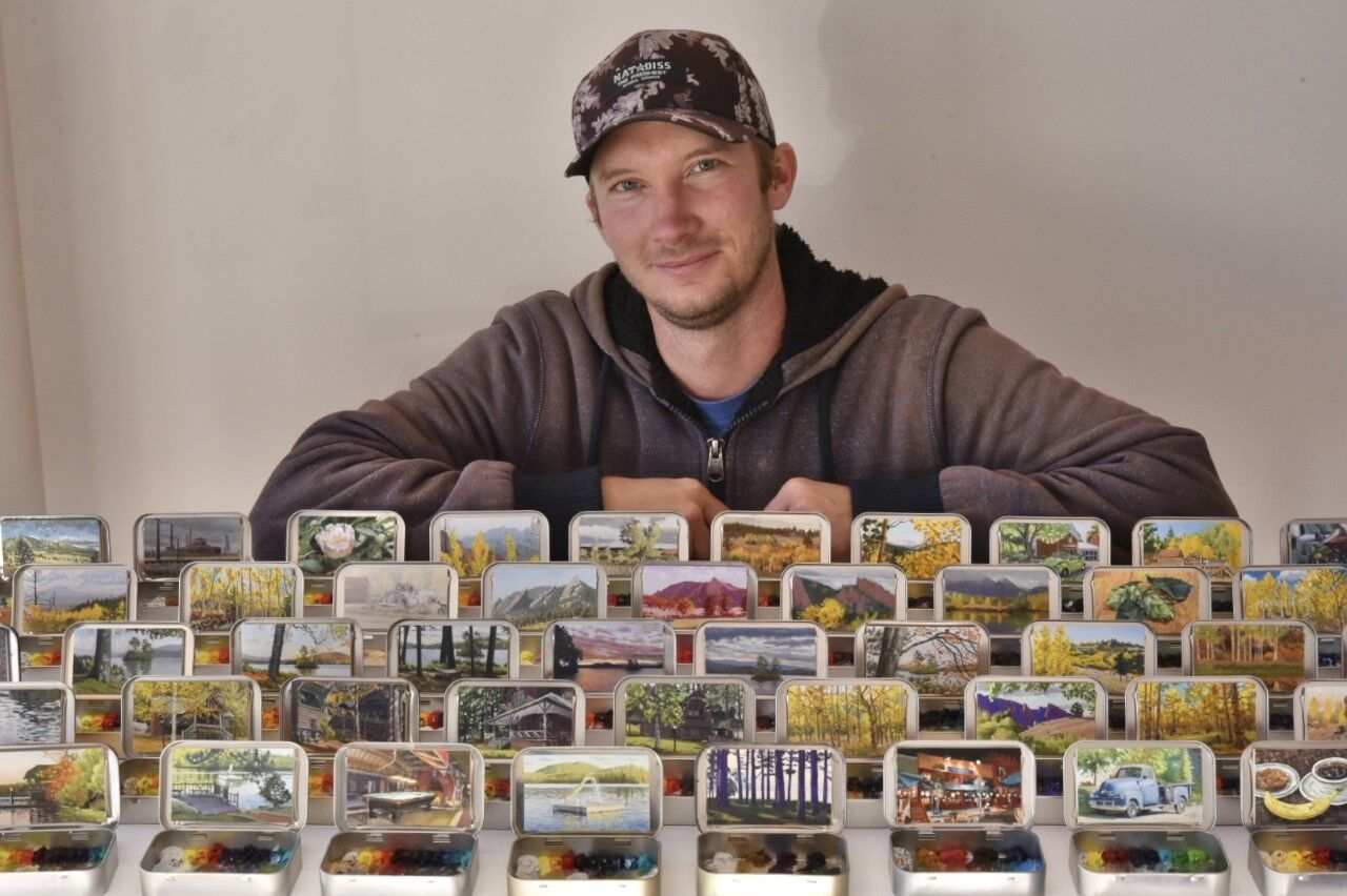 Remington Robinson poses with some of his miniature murals. (Contributed photo)