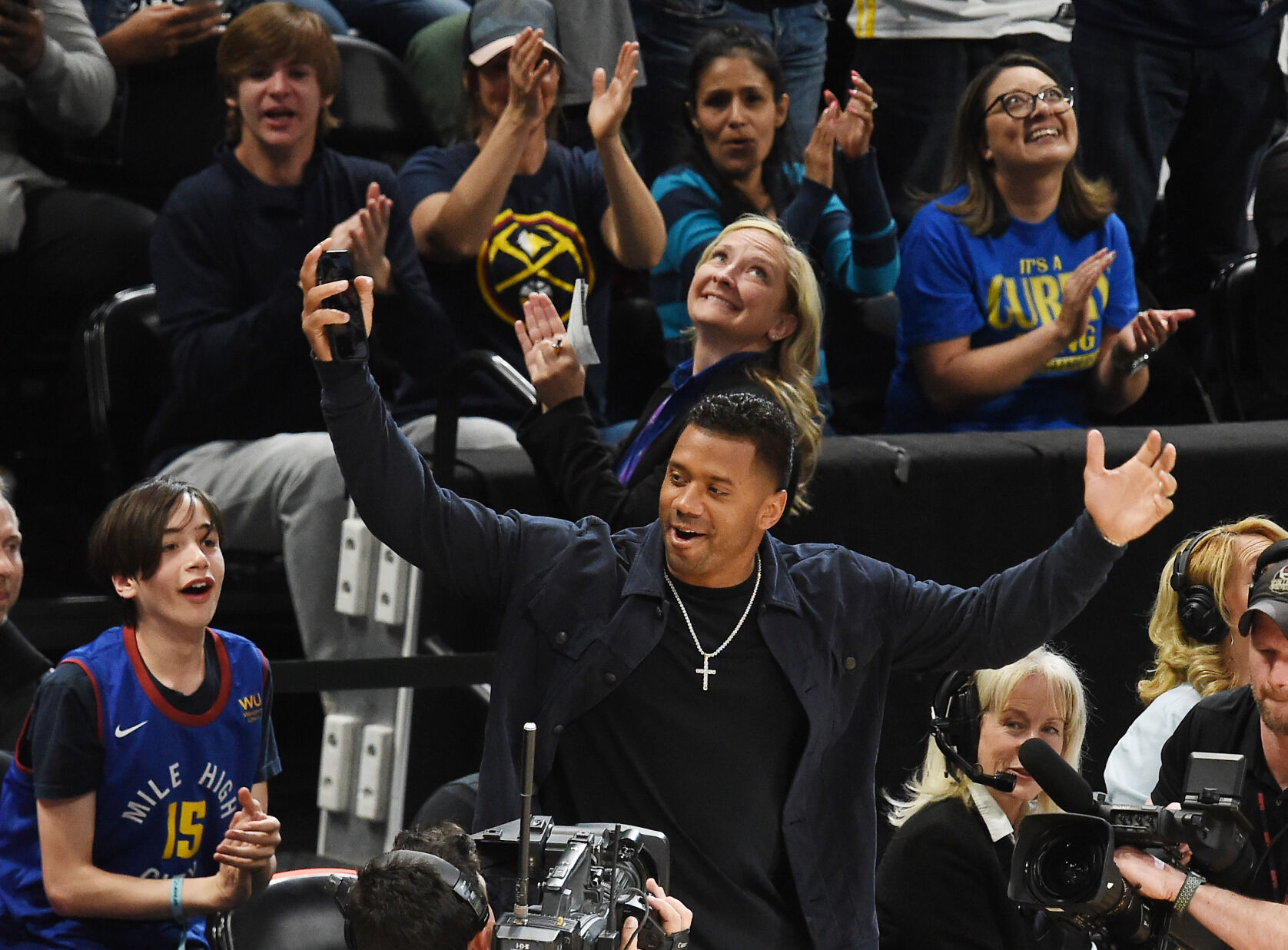 Denver Broncos quarterback Russell Wilson gets the cheering going for the Nuggets during the first quarter of the game against the Warriors at Ball Arena on Sunday, April 24, 2022. (Photo by Jerilee Bennett, The Gazette) (Jerilee Bennett)