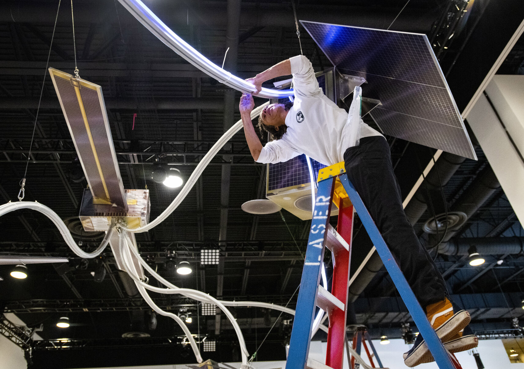 Chris Williams works on the Lockheed Martin display for the 36th Space Symposium on Aug. 20, 2021, inside The Broadmoor’s new Bartolin Hall. (Christian Murdock, Gazette file)