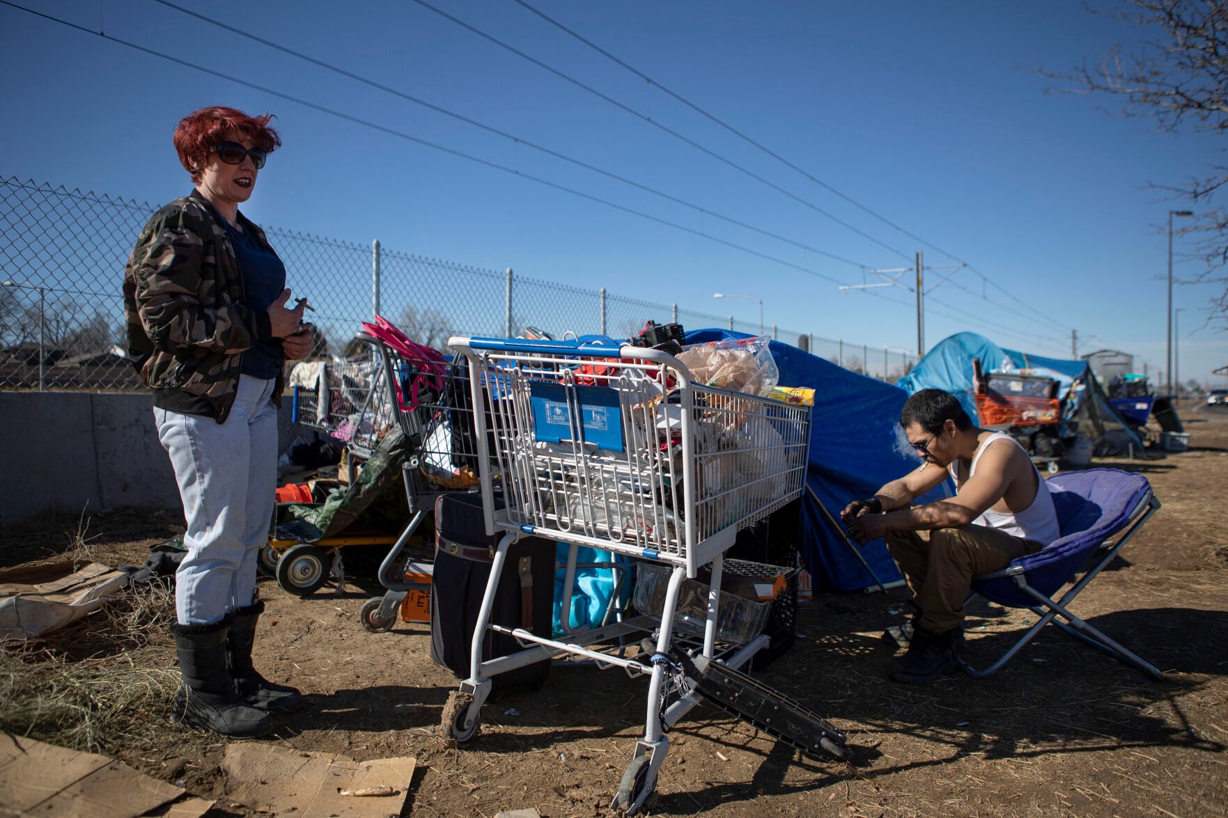 Angel, left, and friend Sleepy discuss the difficulties of living in a camp after picking up trash between their site and a neighboring site on Monday, Feb. 28, 2022, near I-225 and East Mississippi Avenue in Aurora, Colo. Angel has stacked up debris around her tent to help insulate it from the wind. Out of the first 86 clients of the Office of Public Guardianship, 47 – or more than half – were homeless when they were referred to the office. (Timothy Hurst/The Denver Gazette) (Timothy Hurst)