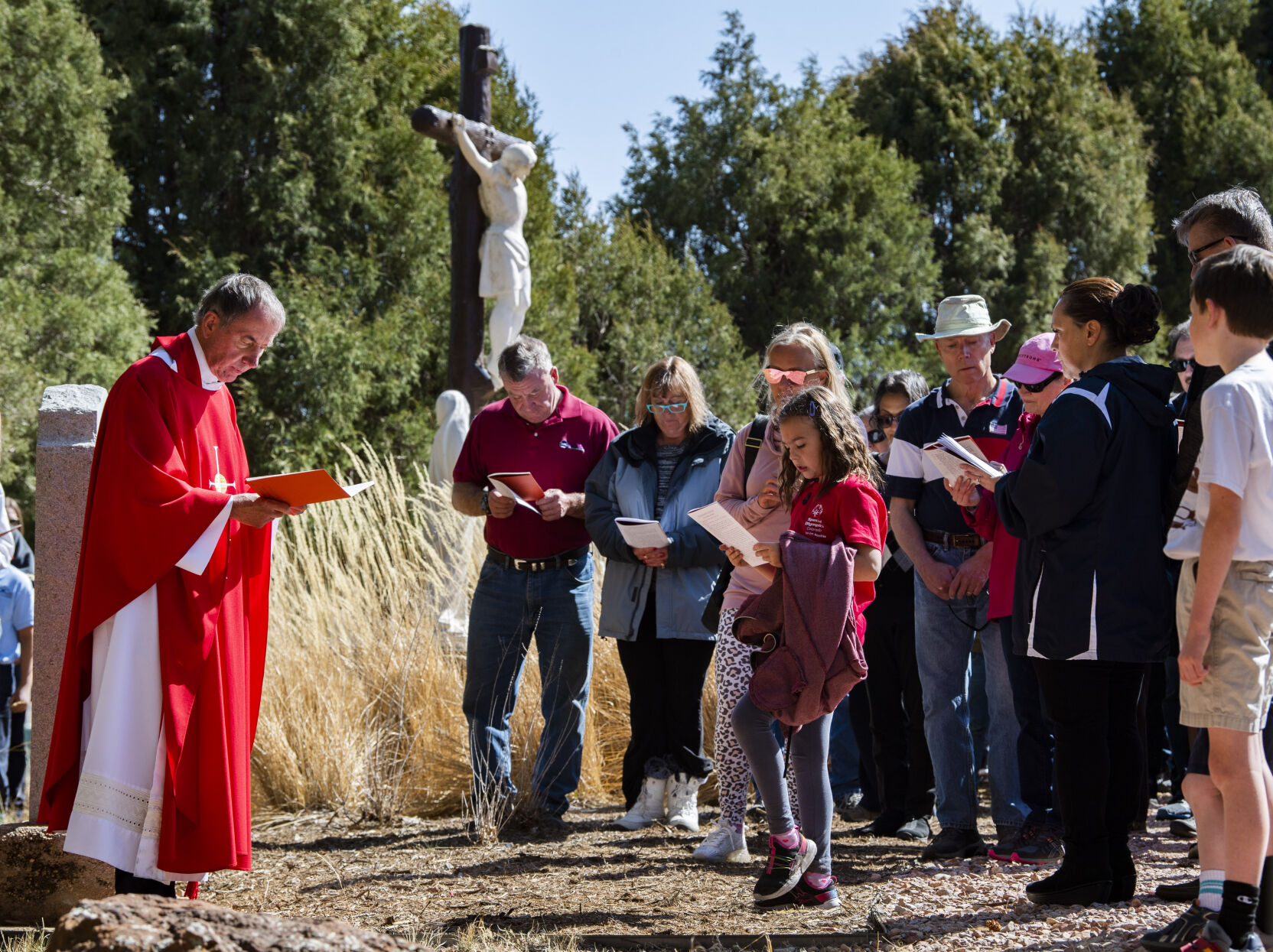 Father Ken Przybyla leads followers through the Stations of the Cross on Good Friday, April 15, 2022, at St. Francis of Assisi Parish in Colorado Springs. (The Gazette, Christian Murdock) (Christian Murdock/The Gazette)