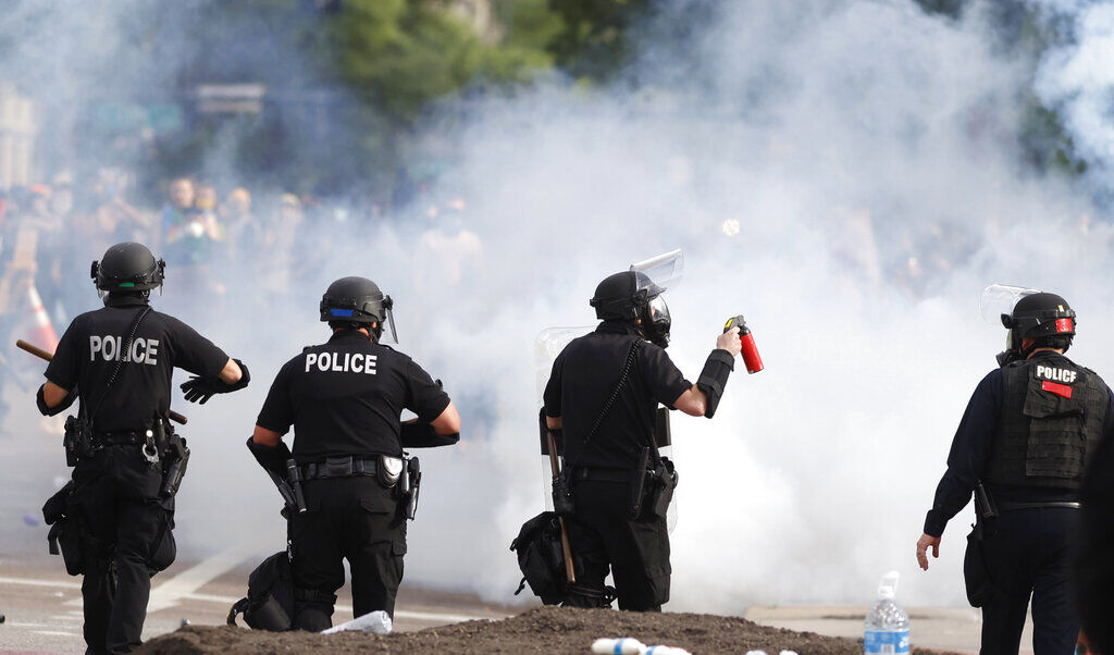FILE -Denver Police move during a protest outside the State Capitol over the death of George Floyd Saturday, May 30, 2020, in Denver. A federal jury’s $14 million award to Denver protesters injured during 2020 demonstrations over the killing of George Floyd could resonate nationwide as courts weigh more than two dozen similar lawsuits.(AP Photo/David Zalubowski, File) (David Zalubowski)