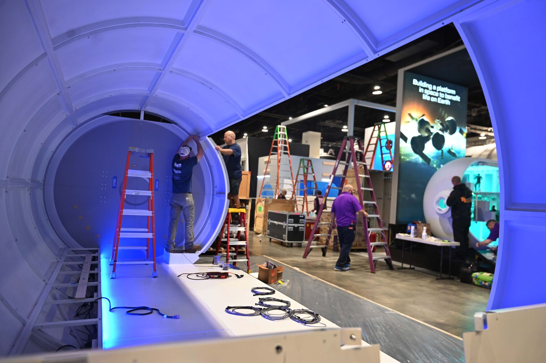 Mike Ouellette and Ben Nikkel work on a mockup of HALO at the Northrop Grumman before the 37th Space Symposium at the Broadmoor on Sunday, April 3, 2022. The Space Symposium starts Monday and 10,000 people will be in attendance.(Photo by Jerilee Bennett, The Gazette) (Jerilee Bennett)