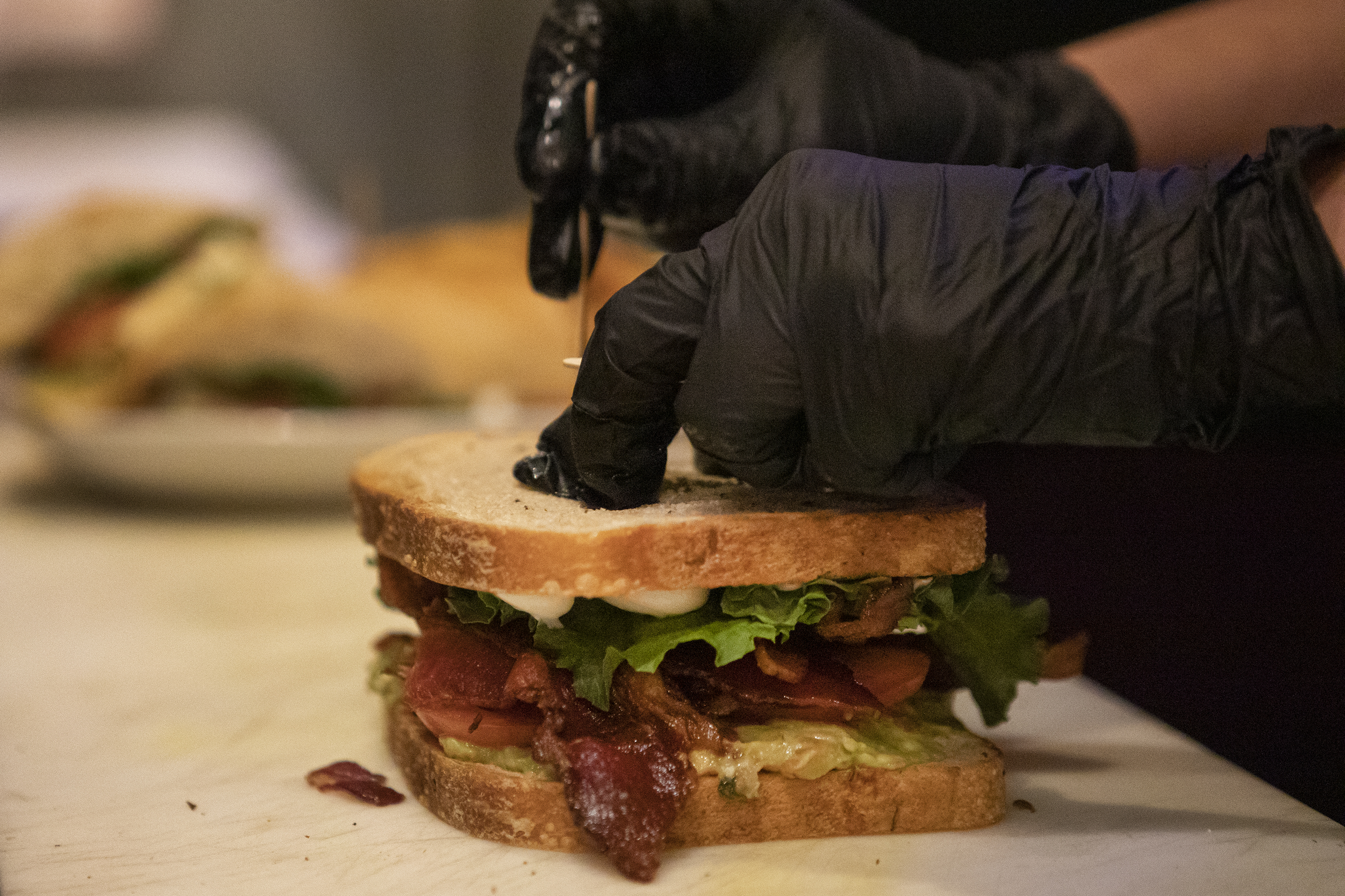 Aspen Bias sticks a pick into a BLT Guacamole on Wednesday, April 13, 2022, at Foolish Craig's Cafe in Boulder, Colo. (Timothy Hurst/The Denver Gazette) (Timothy Hurst)