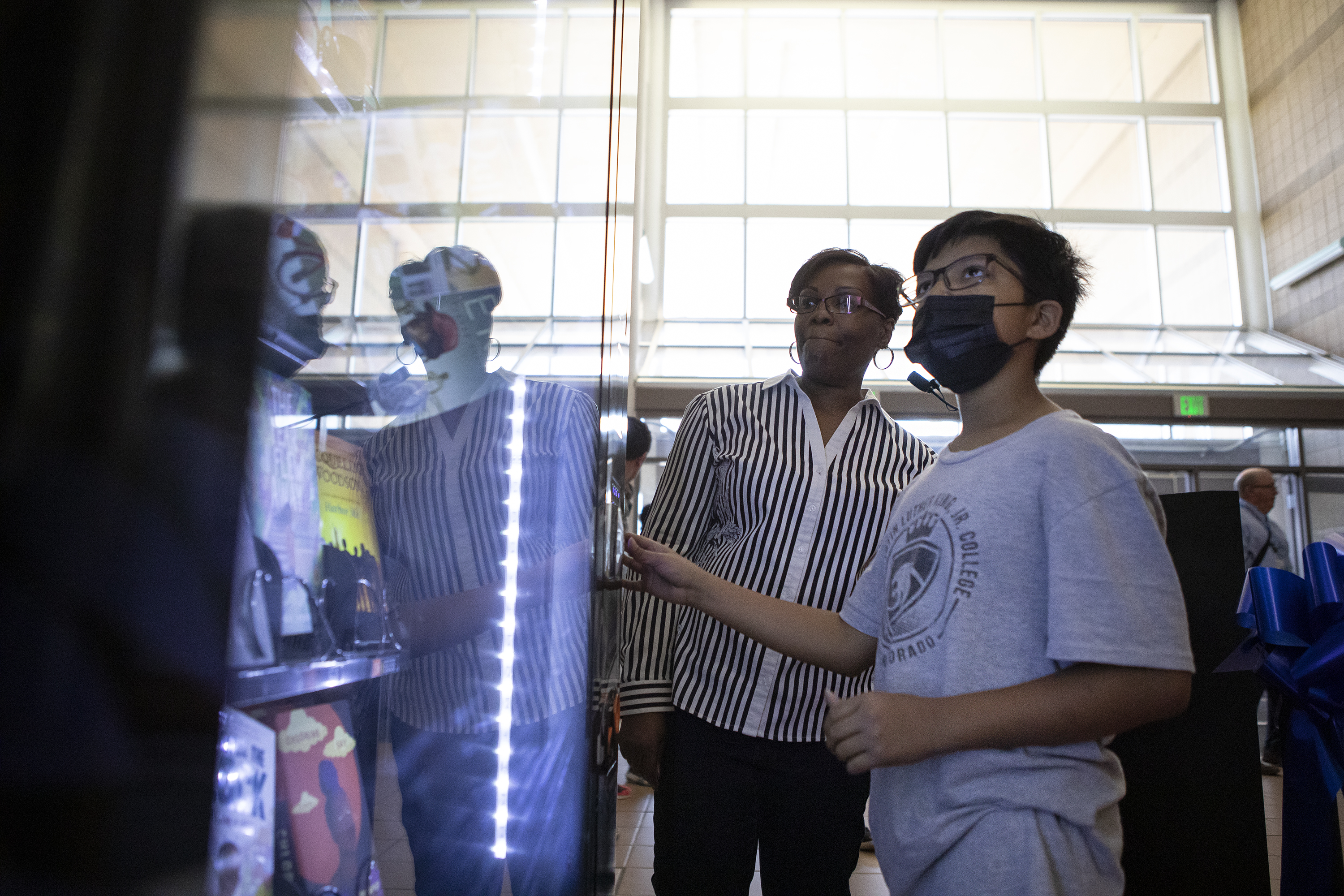 Dr. Martin Luther King, Jr. Early College seventh grader Ajay Quintero picks out the book Long Way Down by Jason Reynolds with librarian Janell Hawkins on Thursday, April 28, 2022, in Denver, Colo. (Timothy Hurst/The Denver Gazette) (Timothy Hurst)