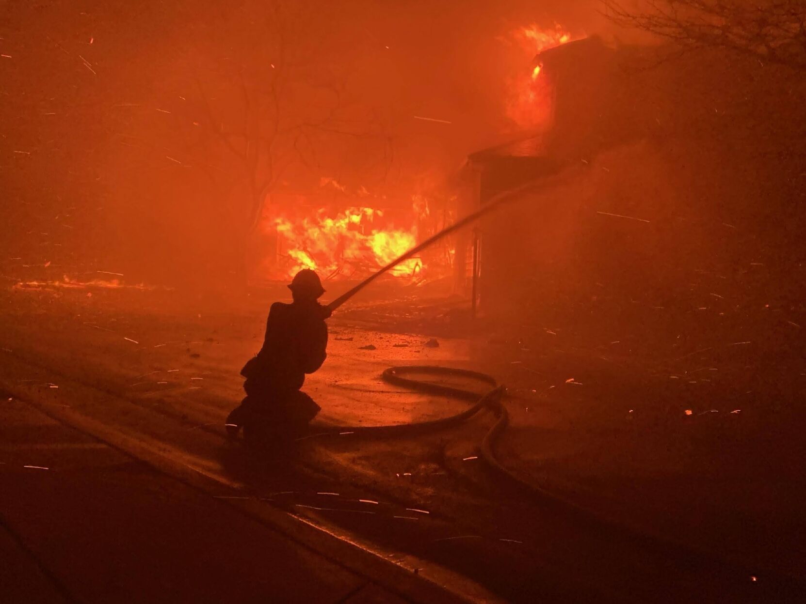 Firefighters the night of Dec. 30 in The Ridge at Superior tried but the fire was burning too hot to save Sandy Quiller's home. Her home is the ball of fire on the far left. (Sandy Quiller)