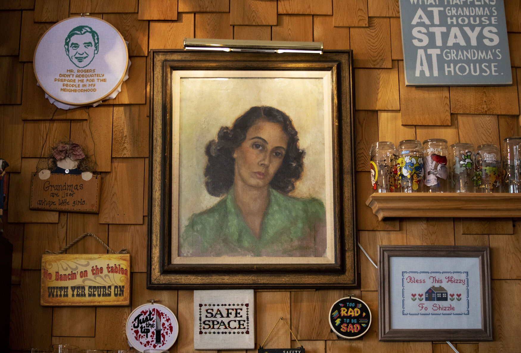 A self-portrait painting of owner Matthew Fuerst’s grandmother, Franca, at Grandma’s House in July 2021. Her paintings decorate the walls of the taproom. (Chancey Bush, Gazette file)