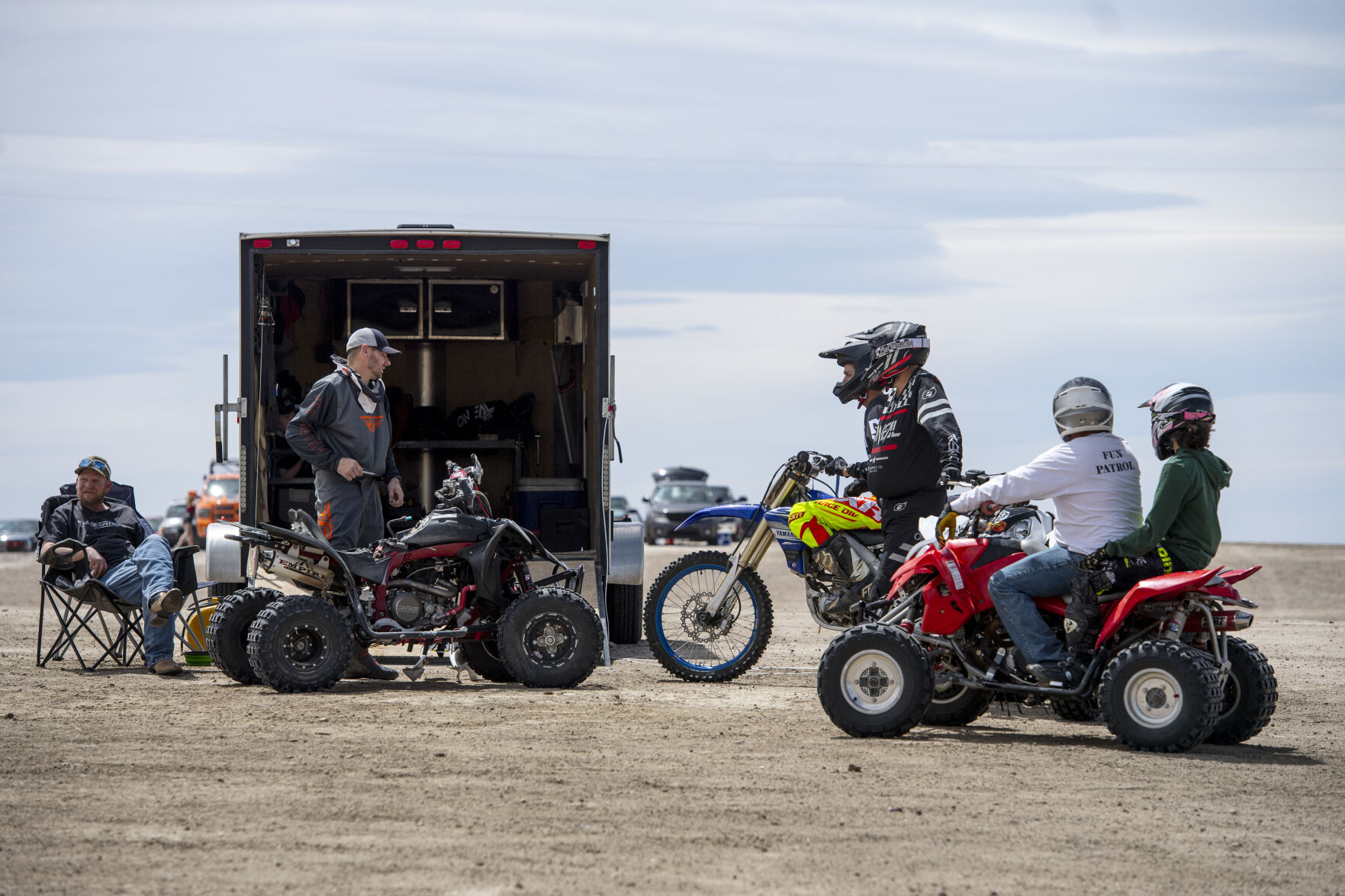 A group of regular park goers gather at Brian Barsh’s trailer as he works on his quad on Saturday, May 7. (Parker Seibold / The Gazette) (Parker Seibold / The Gazette)